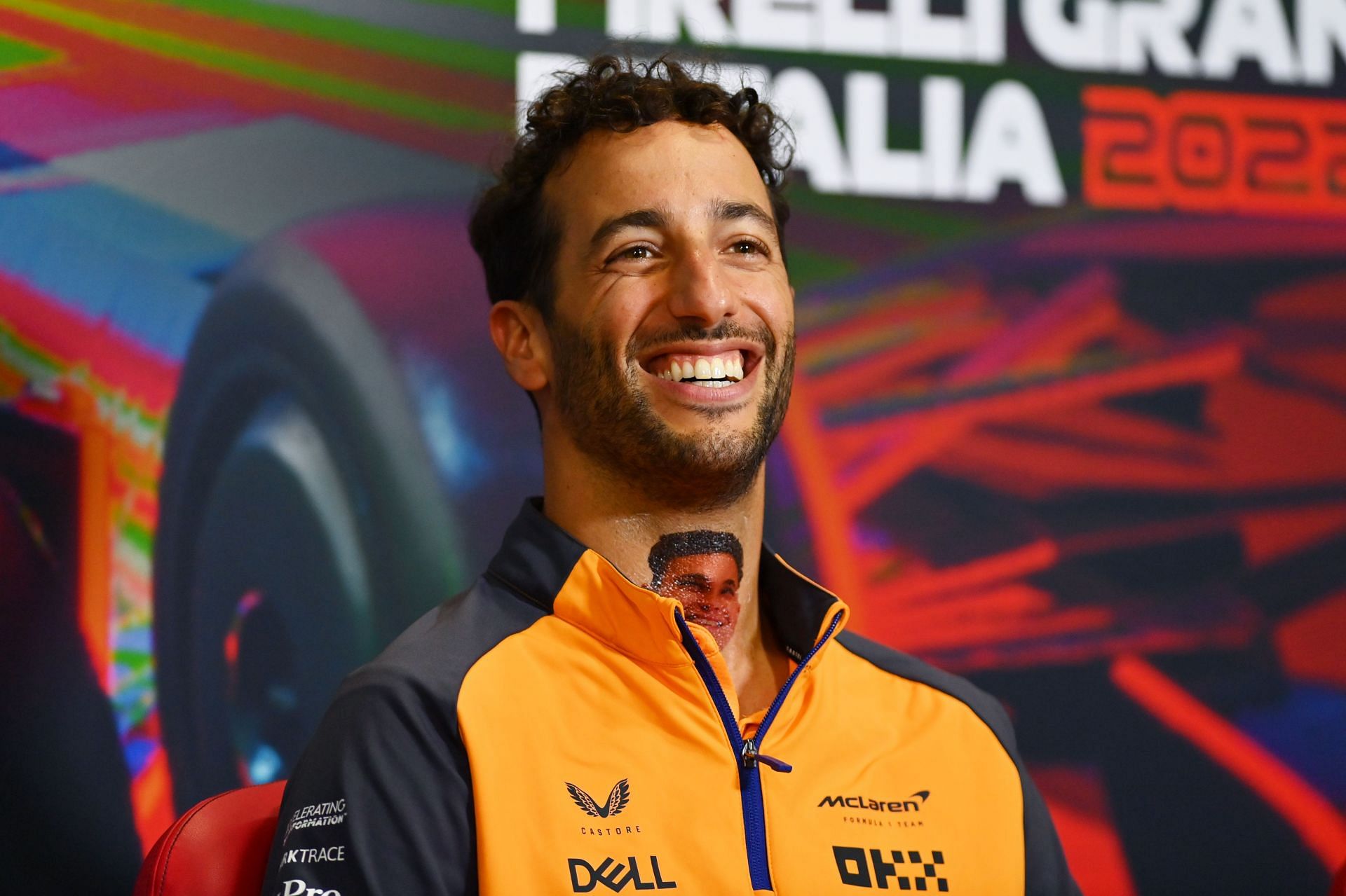 F1 Grand Prix of Italy - Previews Daniel Ricciardo of Australia and McLaren shows a fake tattoo of Lando Norris of Great Britain and McLaren on his neck during the drivers press conference during previews ahead of the F1 Grand Prix of Italy at Autodromo Nazionale Monza on September 08, 2022 in Monza, Italy. (Photo by Dan Mullan/Getty Images)