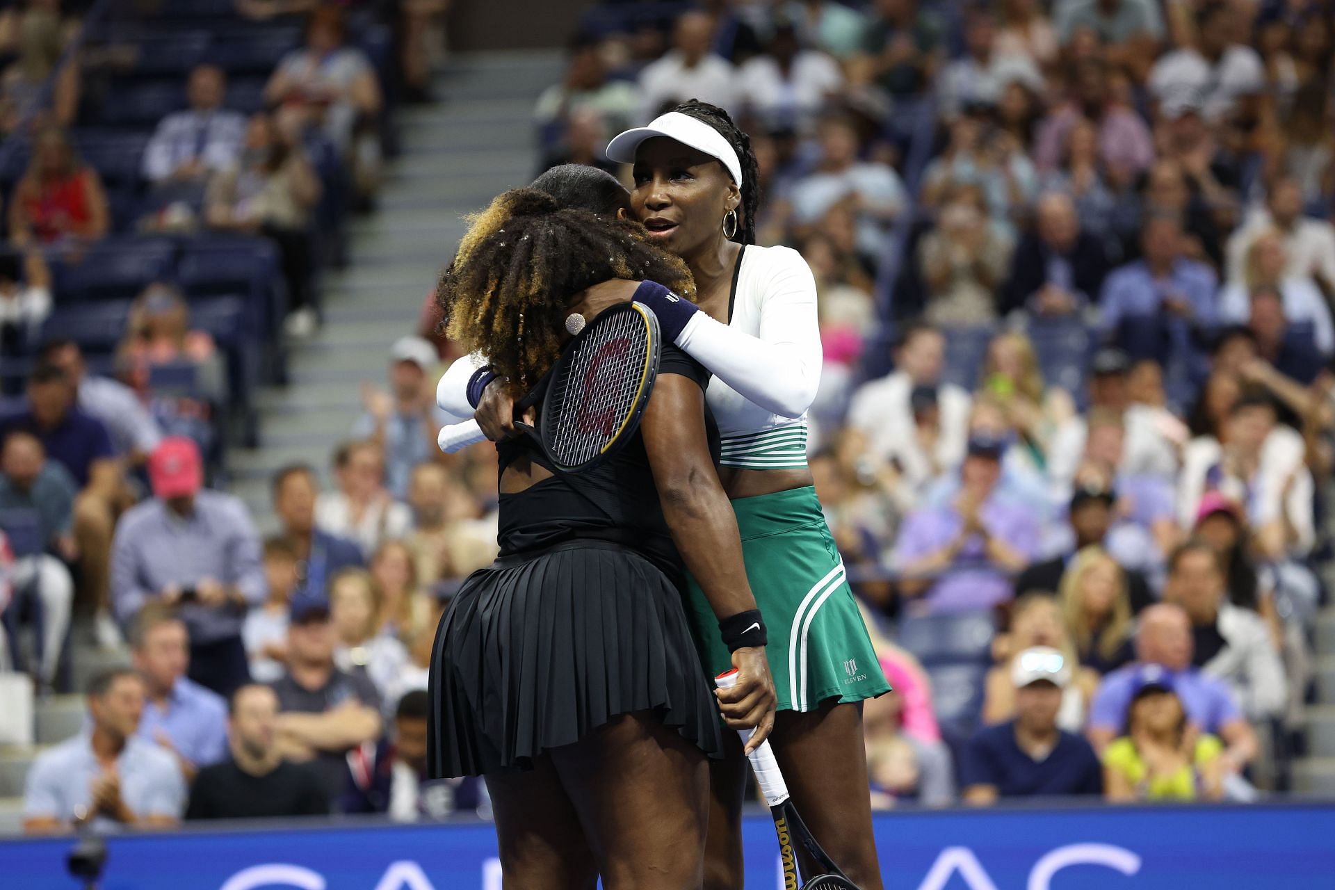 Serena Williams gets a hug from big sister Venus after the pair lost against Lucie Hradecka and Linda Noskova in the first round of doubles action in the US Open.