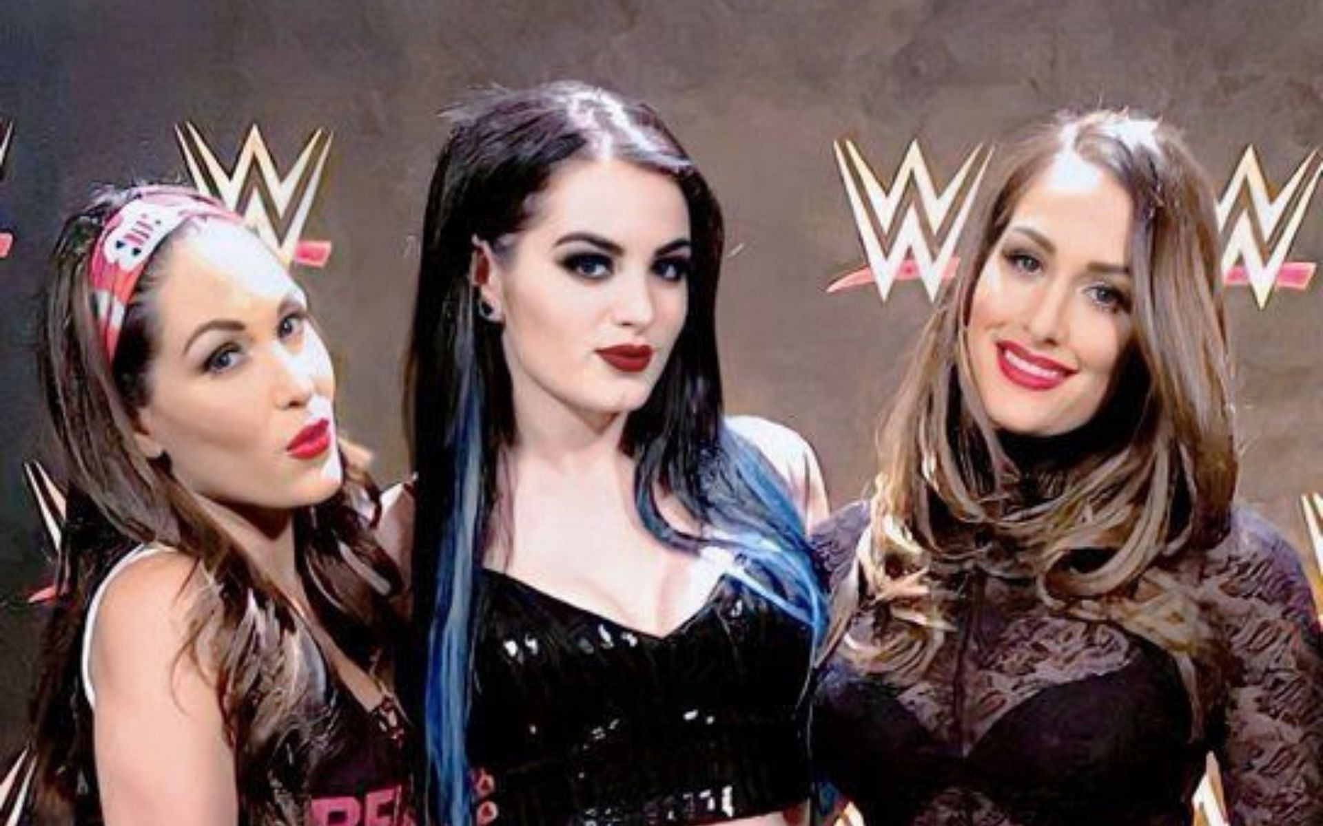 The Bella Twins and Saraya (fka Paige) in a backstage photo together.