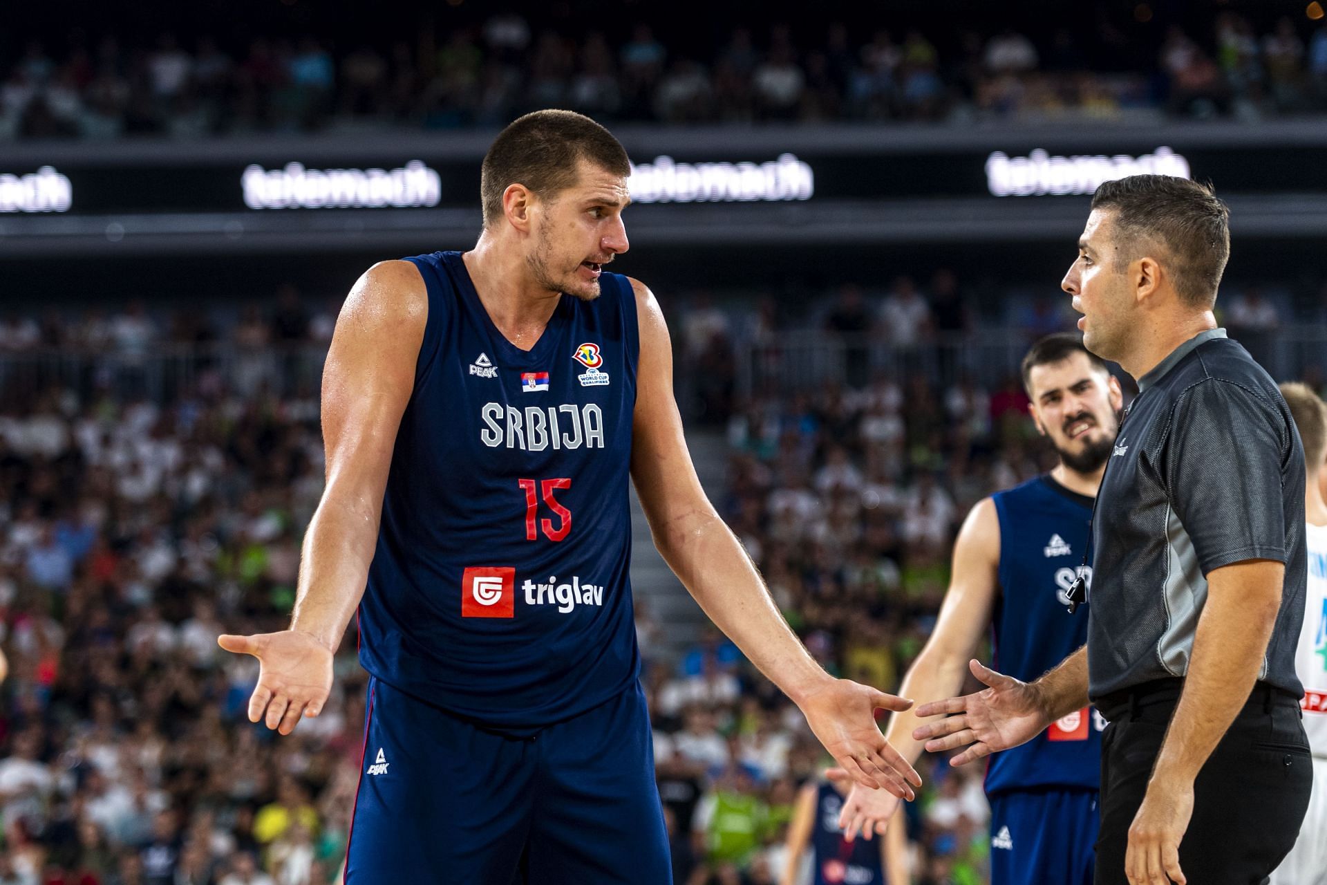 Nikola Jokic argues a call with the referee.