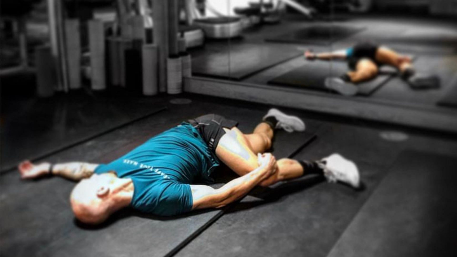 The lying crossover stretch is a full-body stretching exercise. (Photo via Instagram/embracethegrinduk)
