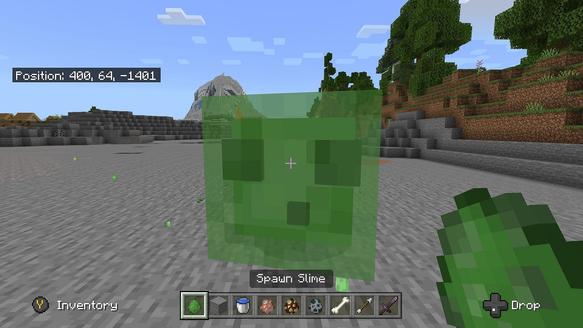 A player spawns a slime using a spawn egg (Image via Mojang)