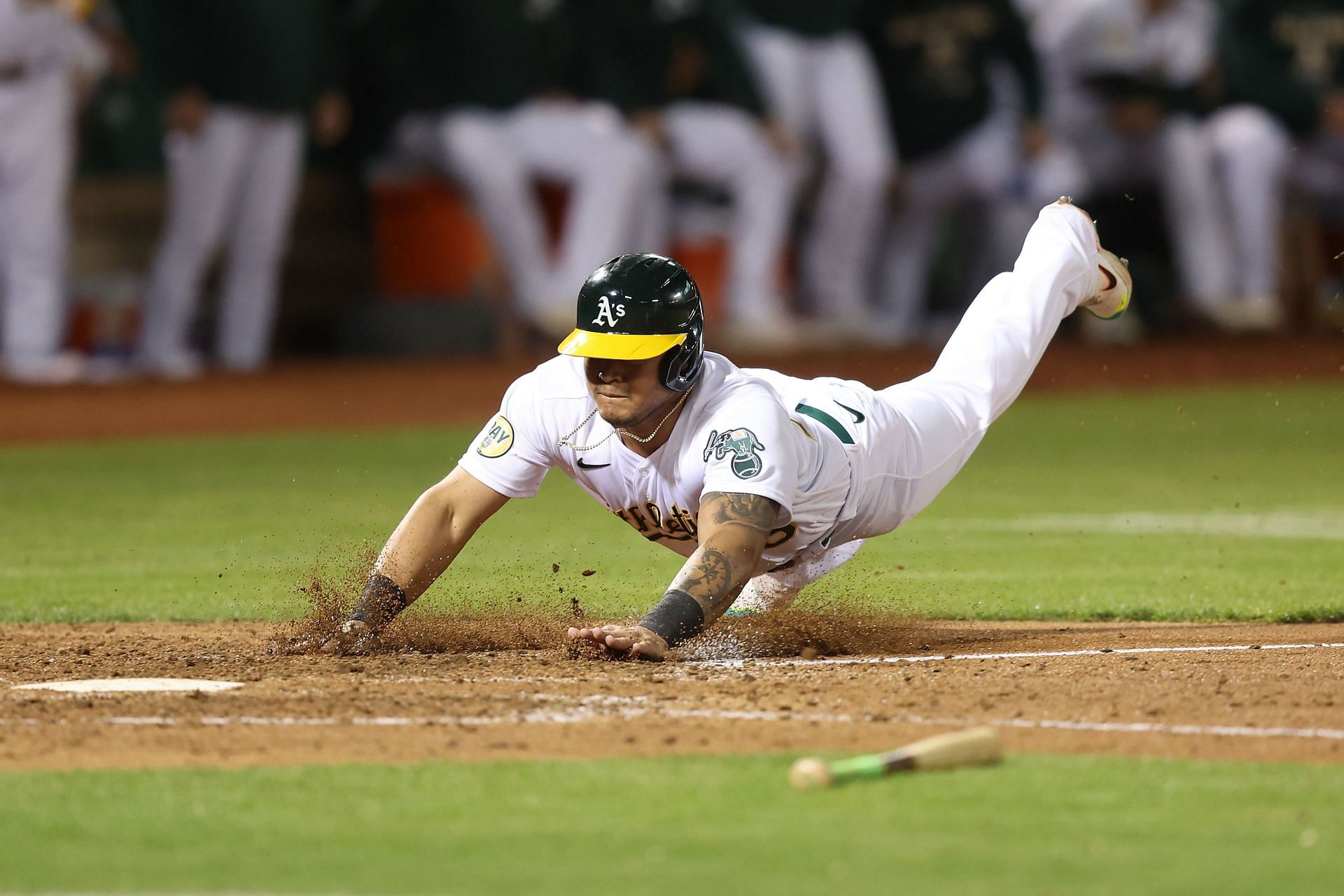 Jordan Diaz #75 of the Oakland Athletics slides into home plate against the Seattle Mariners