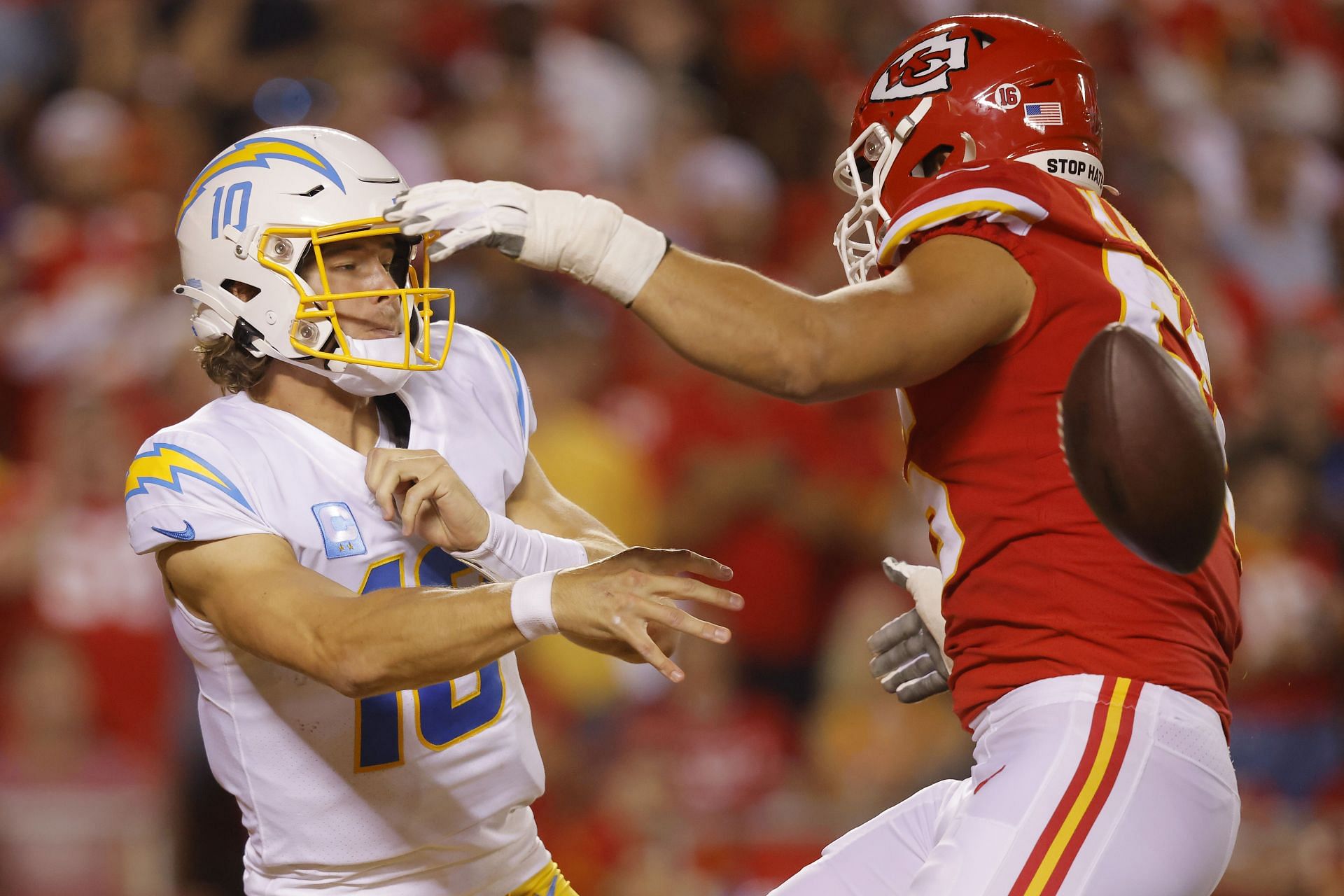 : Justin Herbert #10 of the Los Angeles Chargers throws an incomplete pass as George Karlaftis #56 of the Kansas City Chiefs applies pressure