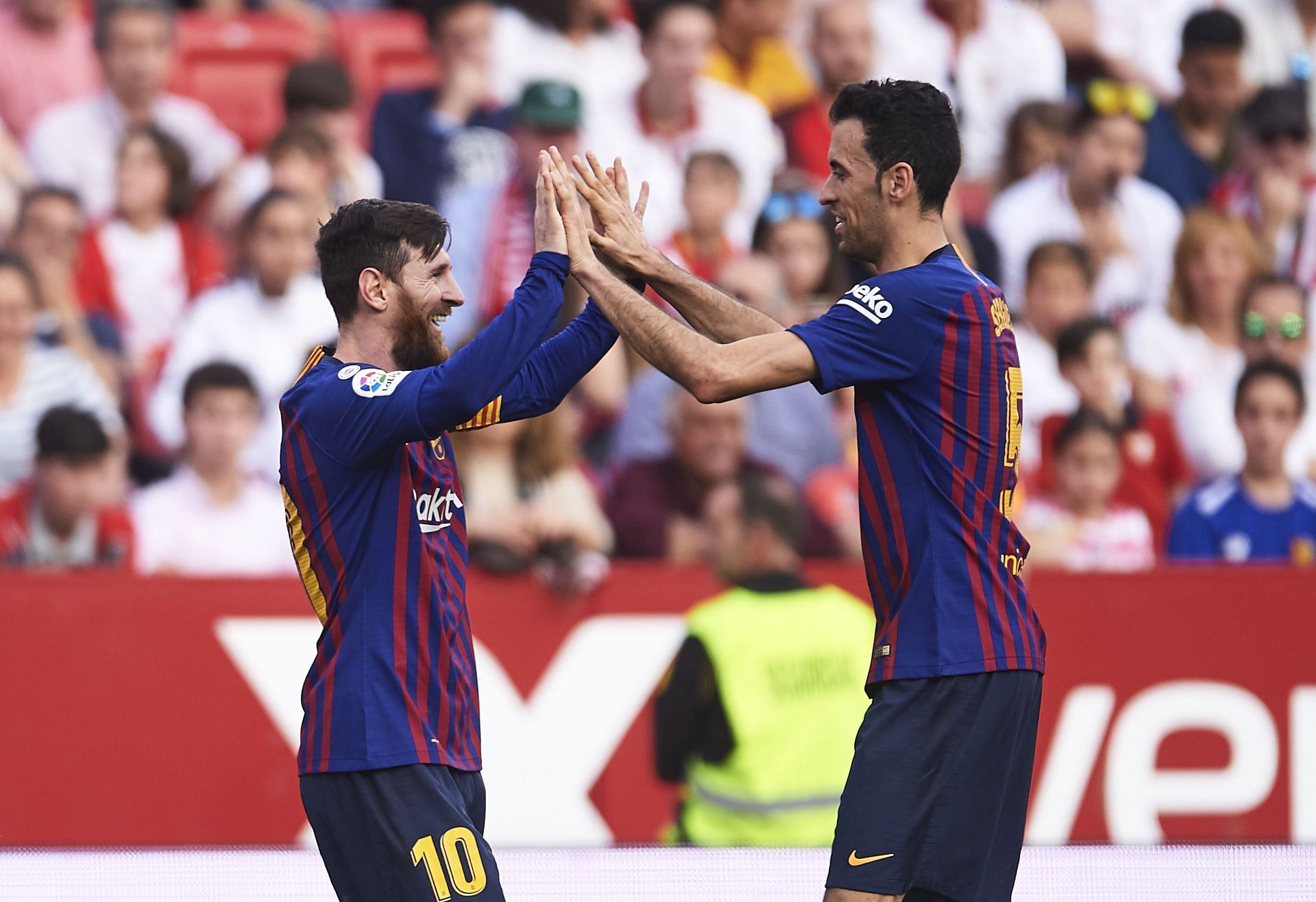 Lionel Messi and Sergio Busquets in action for Barcelona