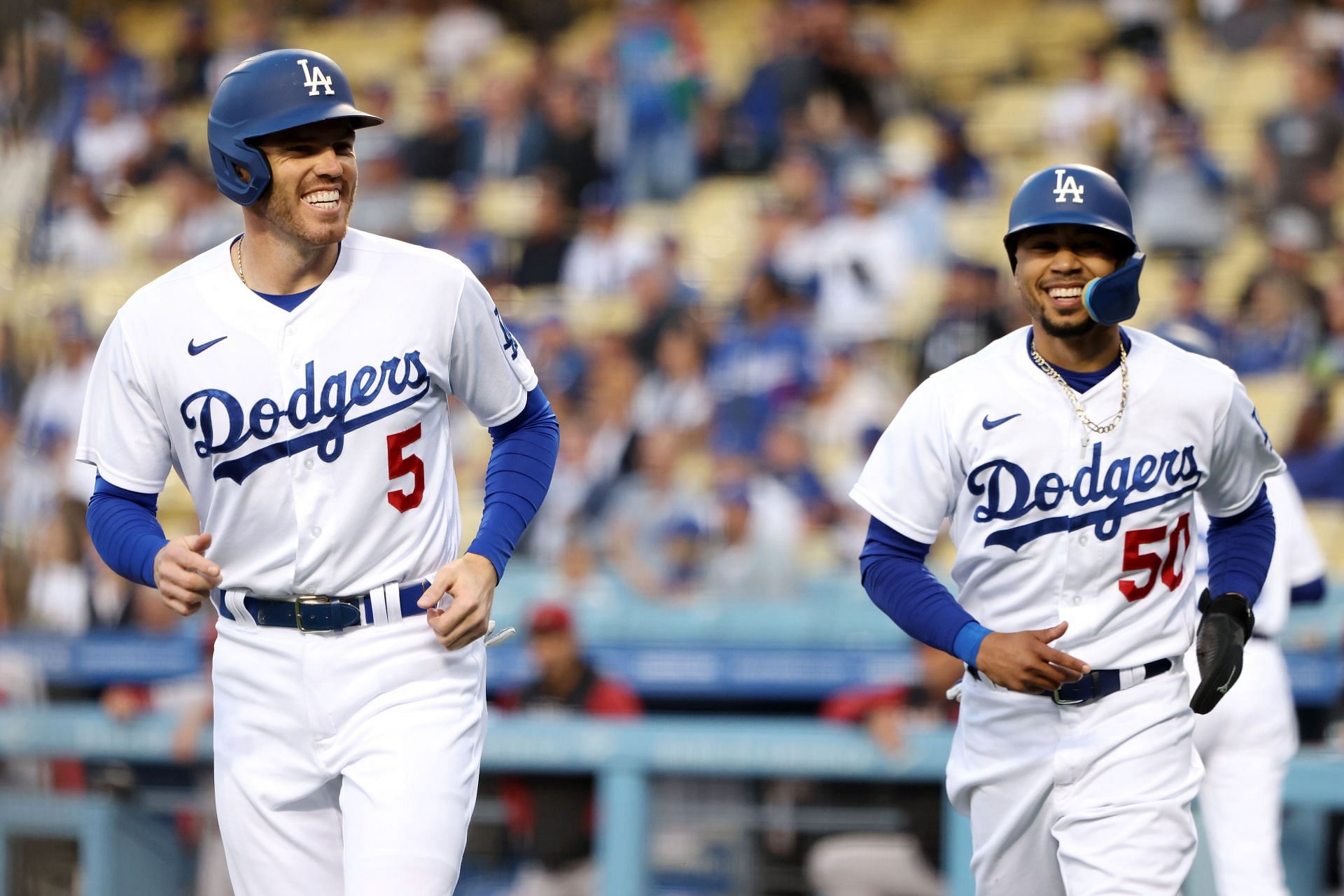 Freddie Freeman #5 and Mookie Betts #50 of the Los Angeles Dodgers react after scoring on a two-run single