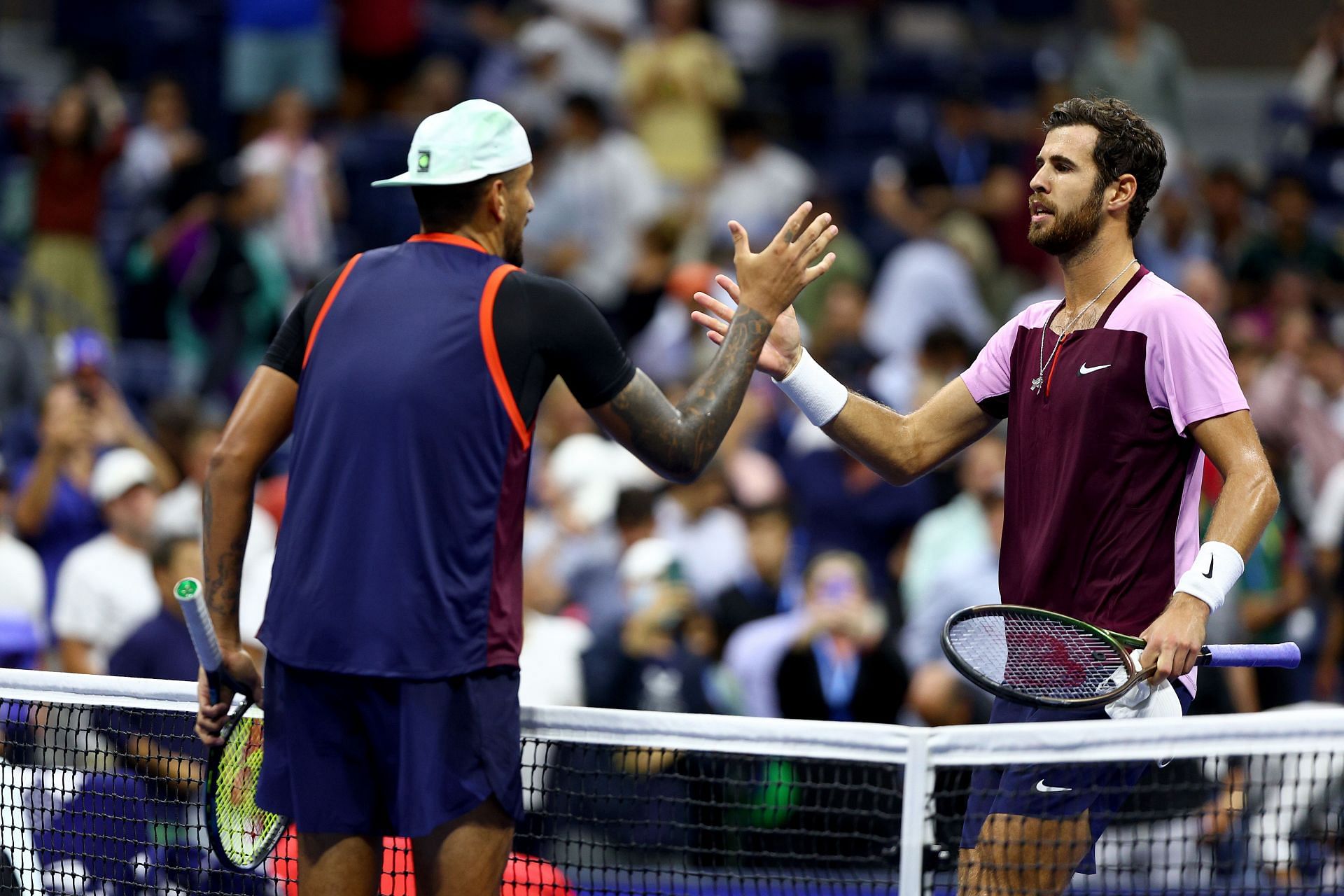 Nick Kyrgios (left) meets Karen Khachanov at the net.