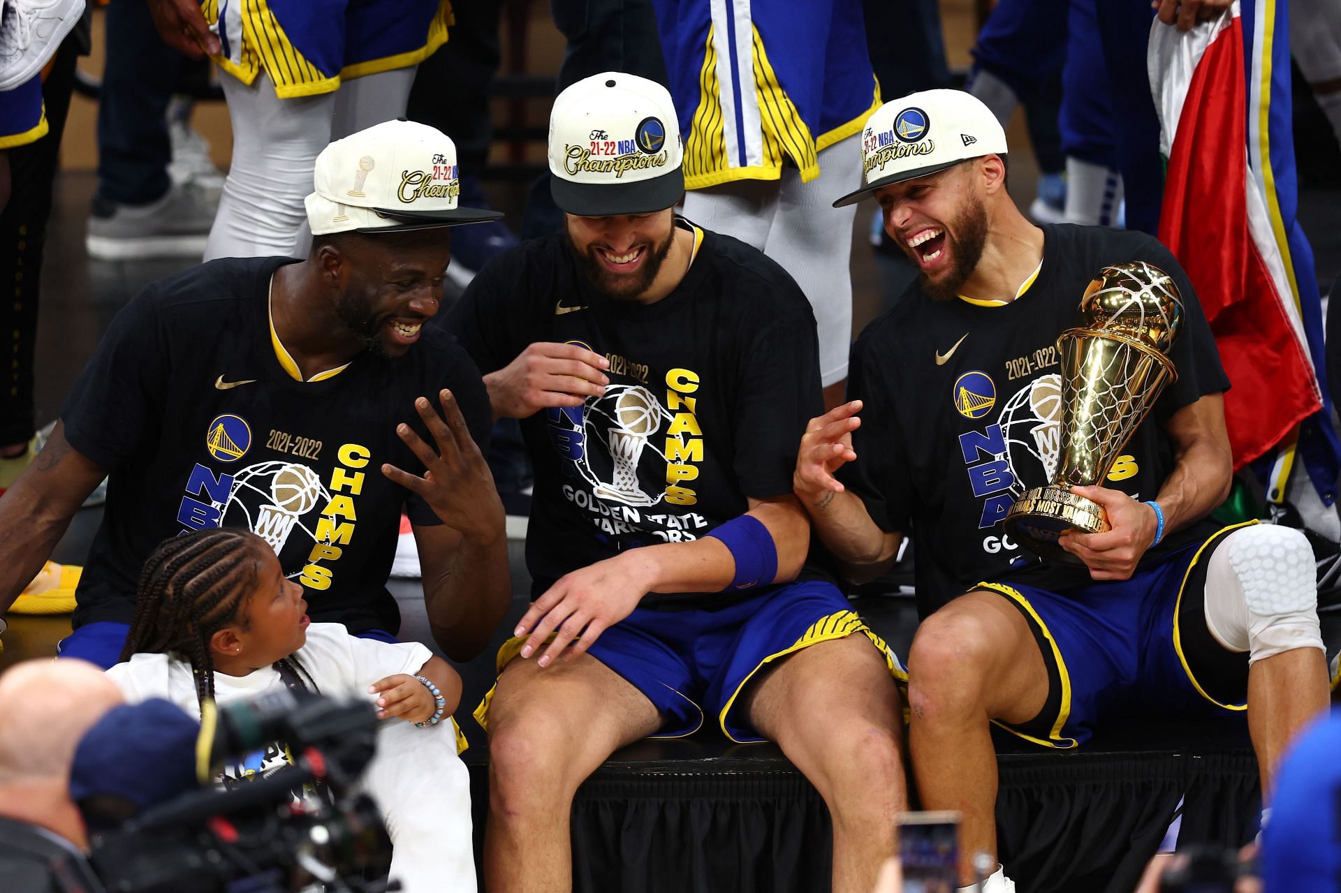 Steph Curry celebrates alongside Draymond Green and Klay Thompson