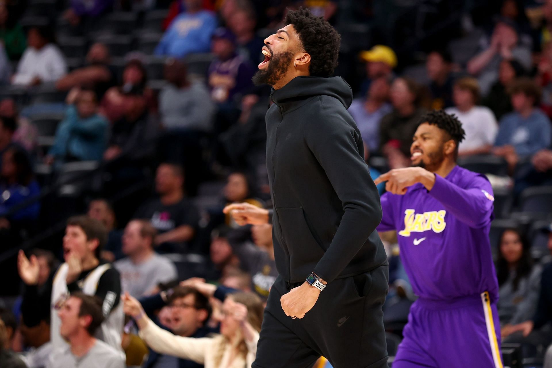 Anthony Davis celebrates a play from the bench