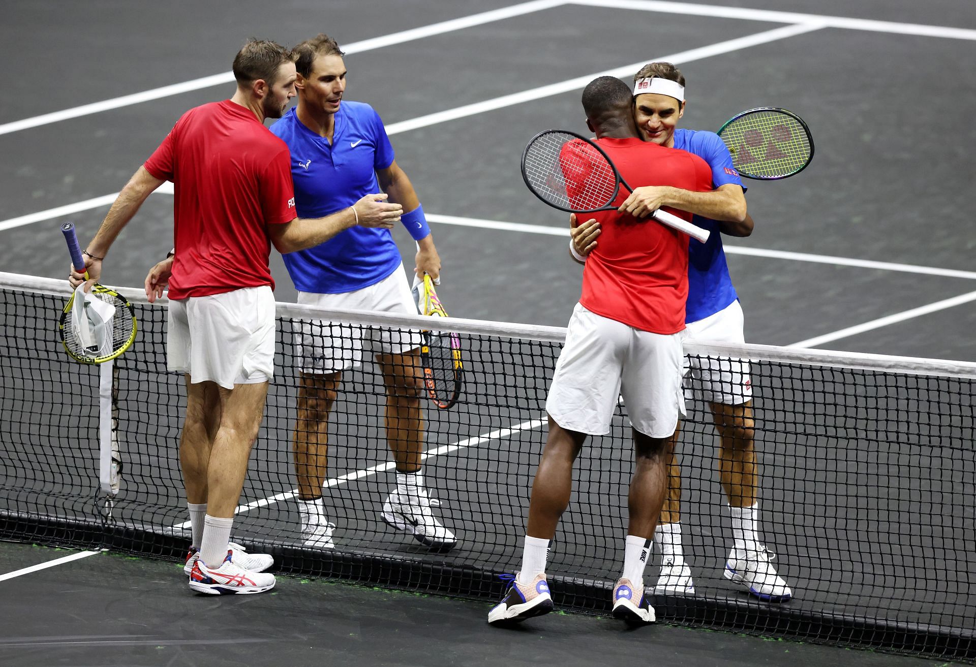 Jack Sock and Frances Tiafoe embrace Rafael Nadal and Roger Federer at the Laver Cup.