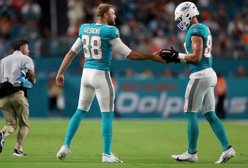 Miami Dolphins tight end Mike Gesicki (88) deflects the ball as