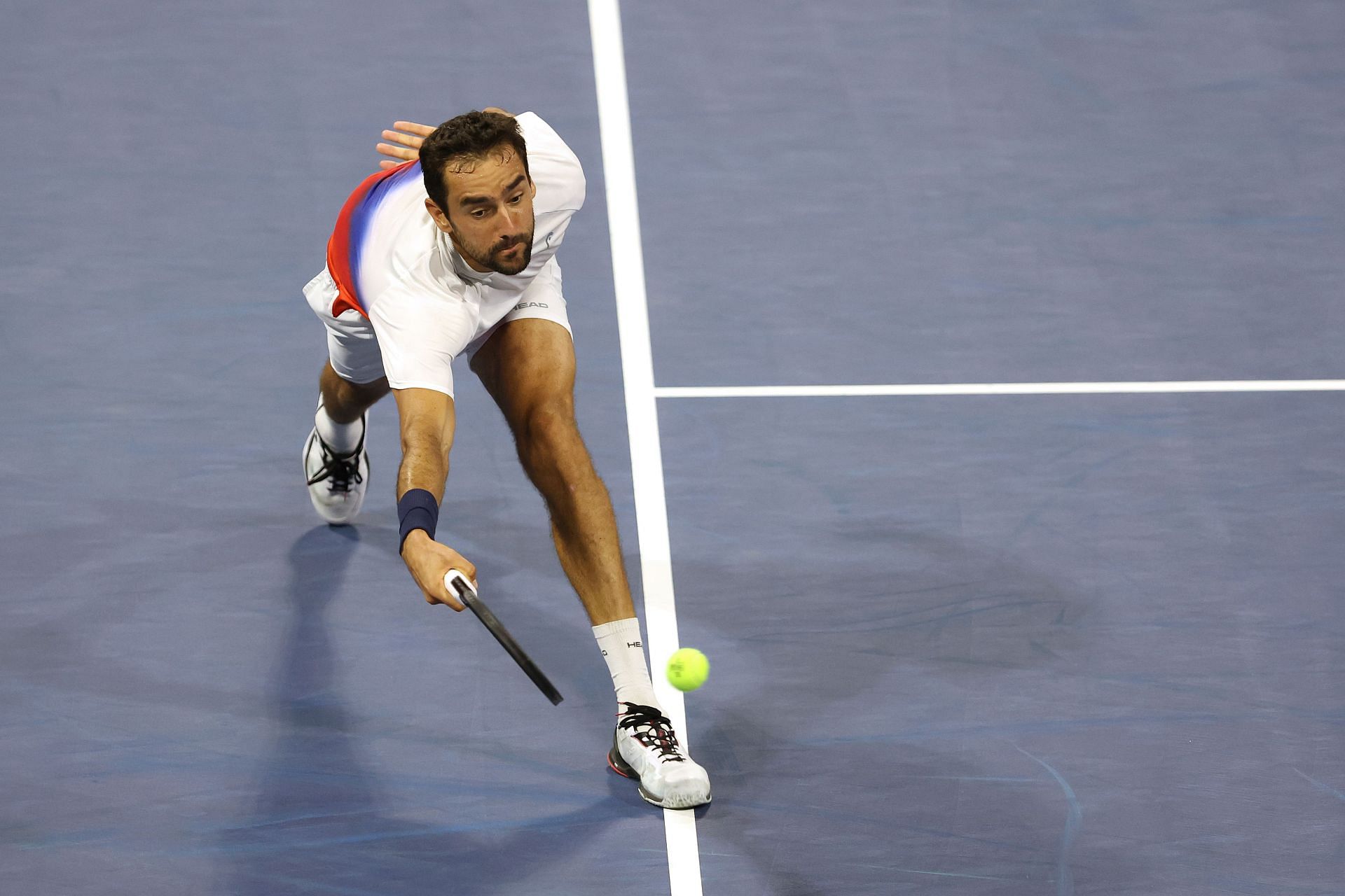 Marin Cilic returns a shot against Daniel Evans during their third-round match at the 2022 US Open - Day 6