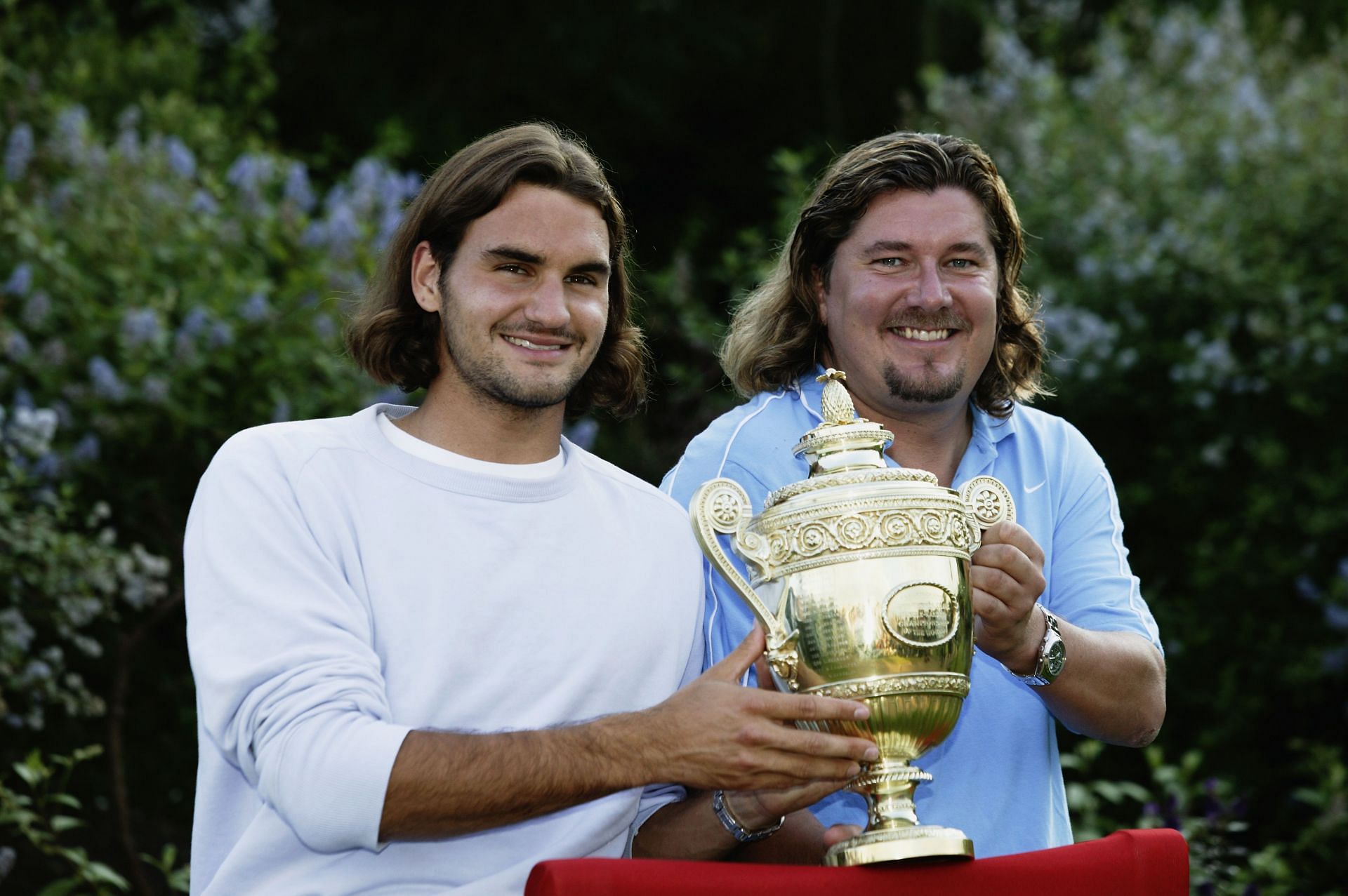 Roger Federer poses with the trophy with his former coach Peter Lundgren