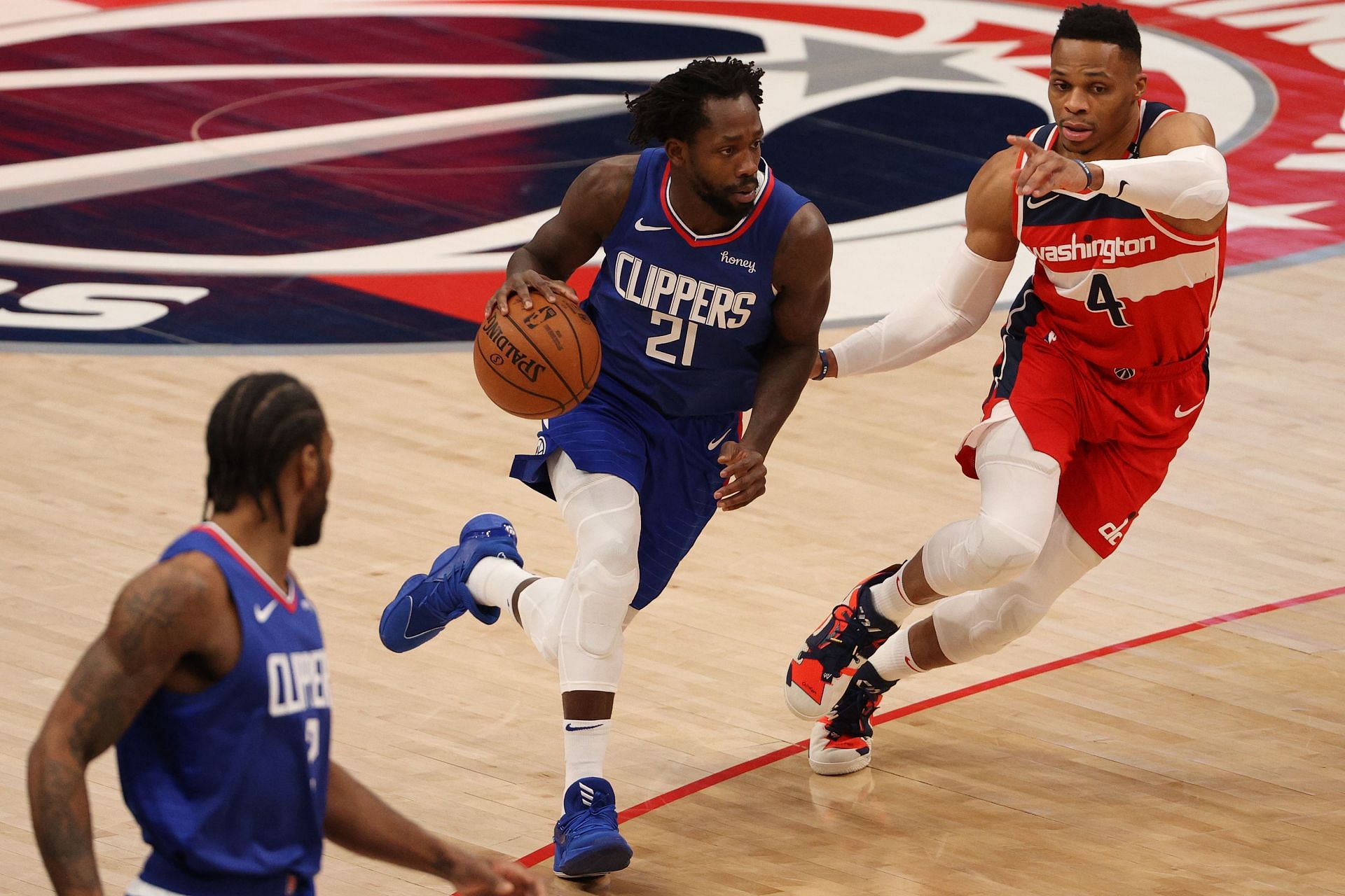Patrick Beverley (21) of the LA Clippers dribbles past Russell Westbrook of the Washington Wizards at Capital One Arena on March 4, 2021, in Washington, D.C.