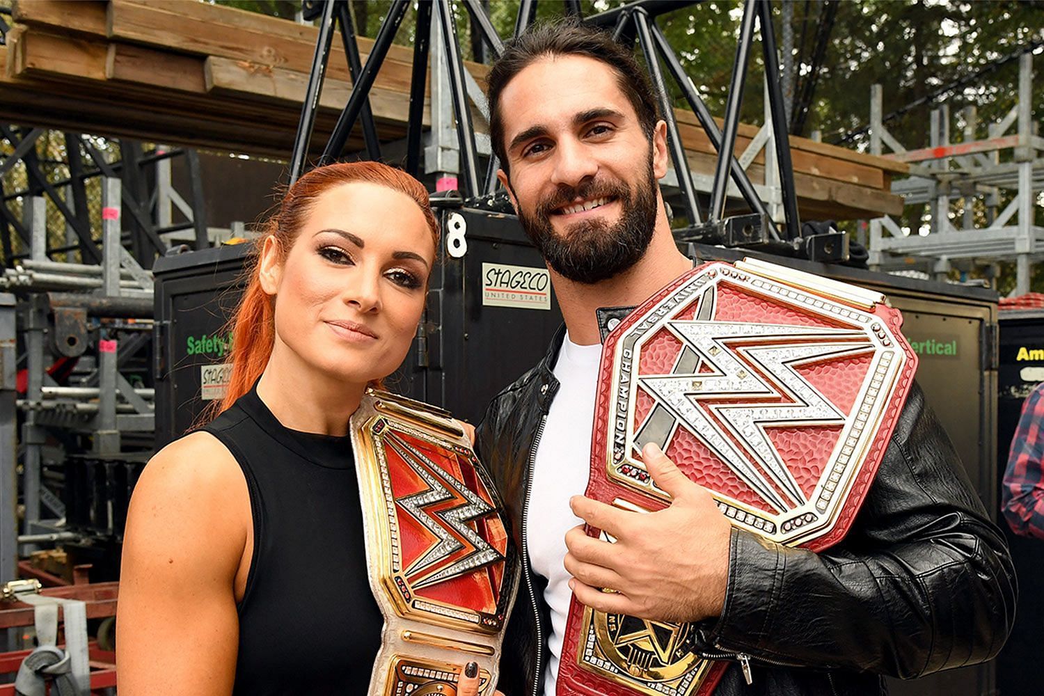 Becky Lynch and Seth Rollins holding their respective titles in 2019.