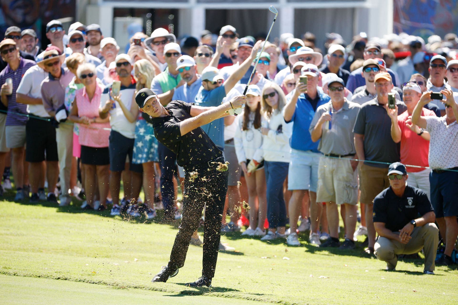 Cam Davis of Australia and the international team play an approach shot on the third hole as fans watch during day two of the 2022 Presidents Cup at Friday's four-ball games (Image via Jared C. Tilton/Getty Images).