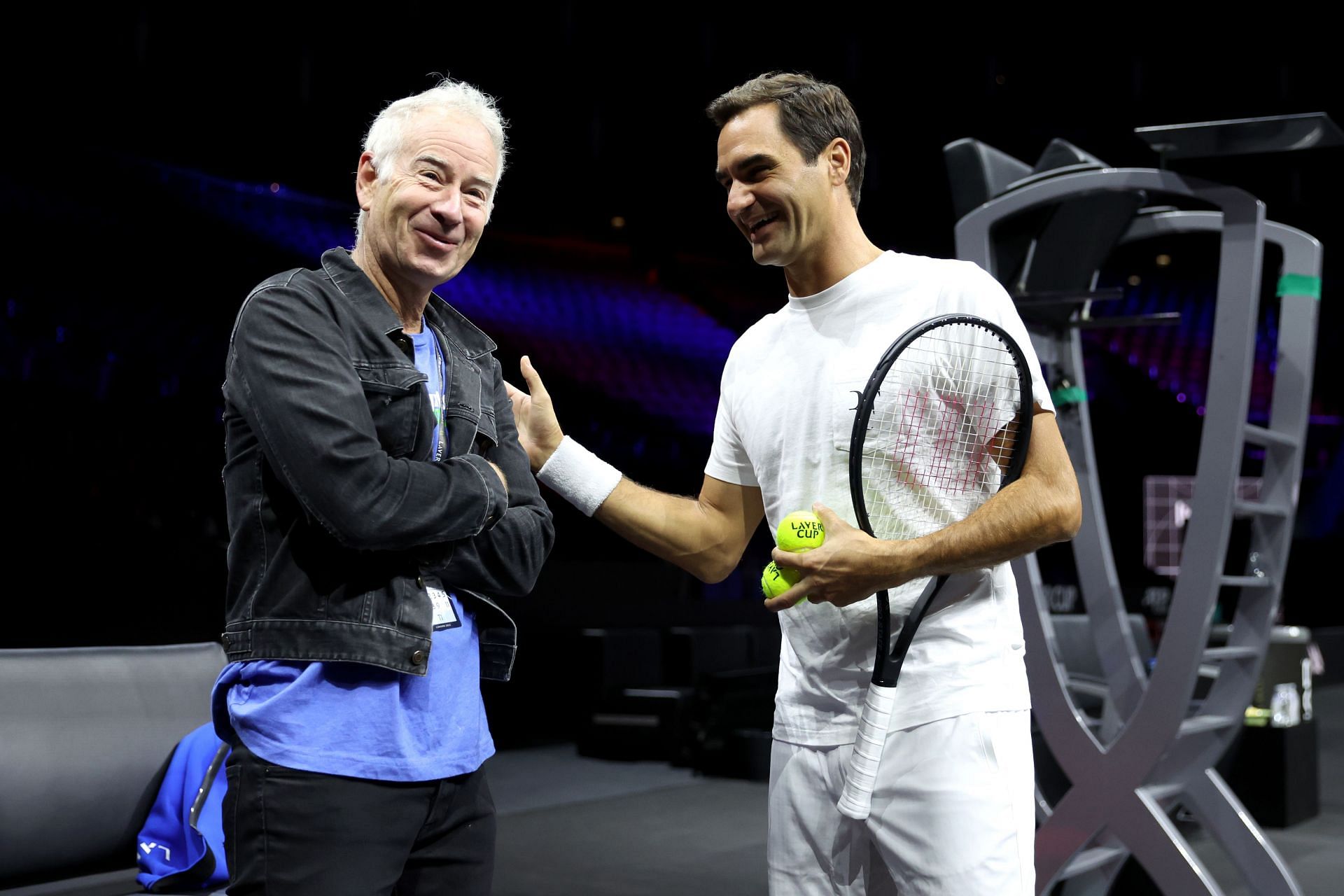 John McEnroe alongside Roger Federer