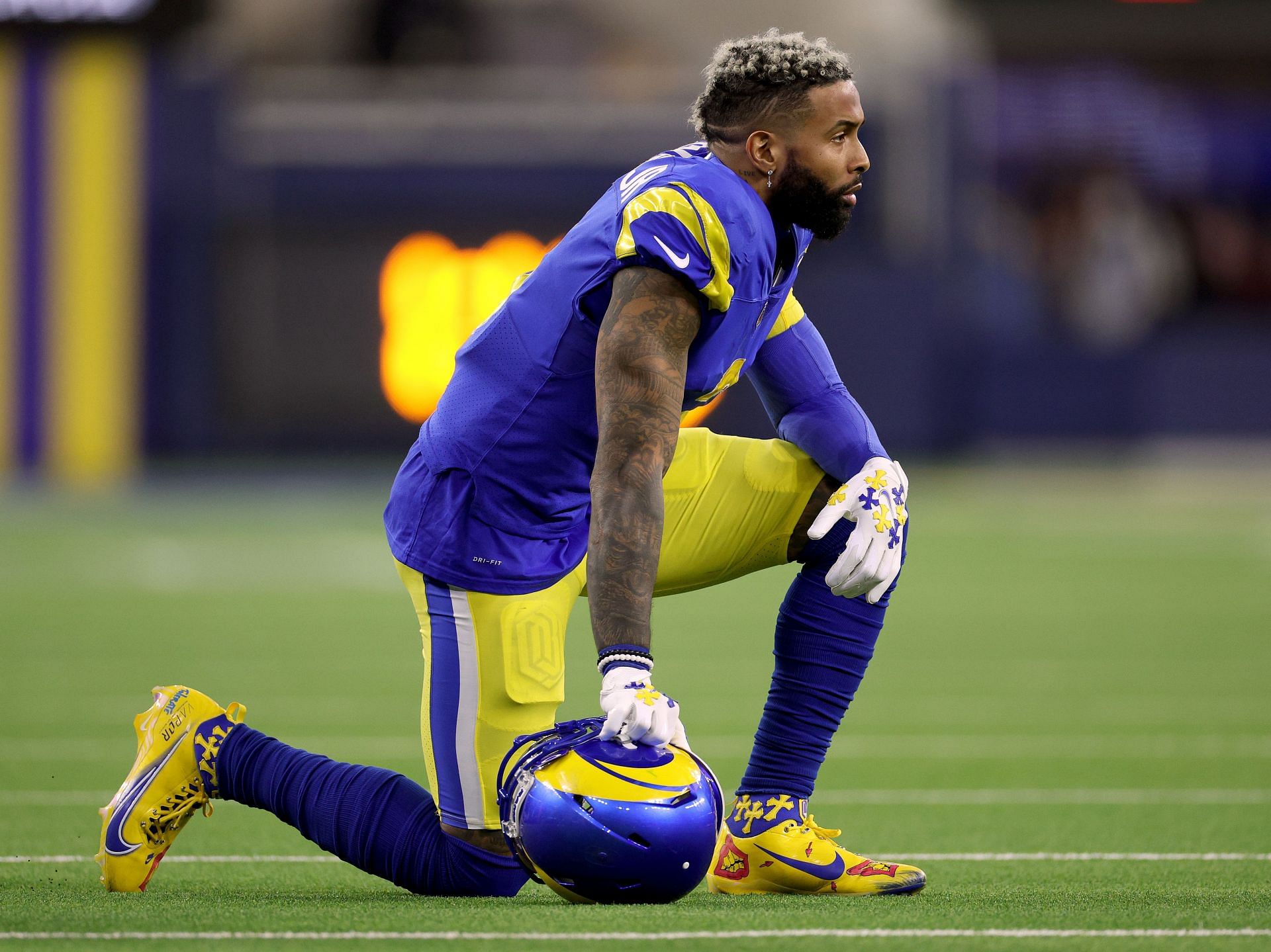 Los Angeles Rams wide receiver Odell Beckham Jr. puts on his helmet during  practice for an NFL …