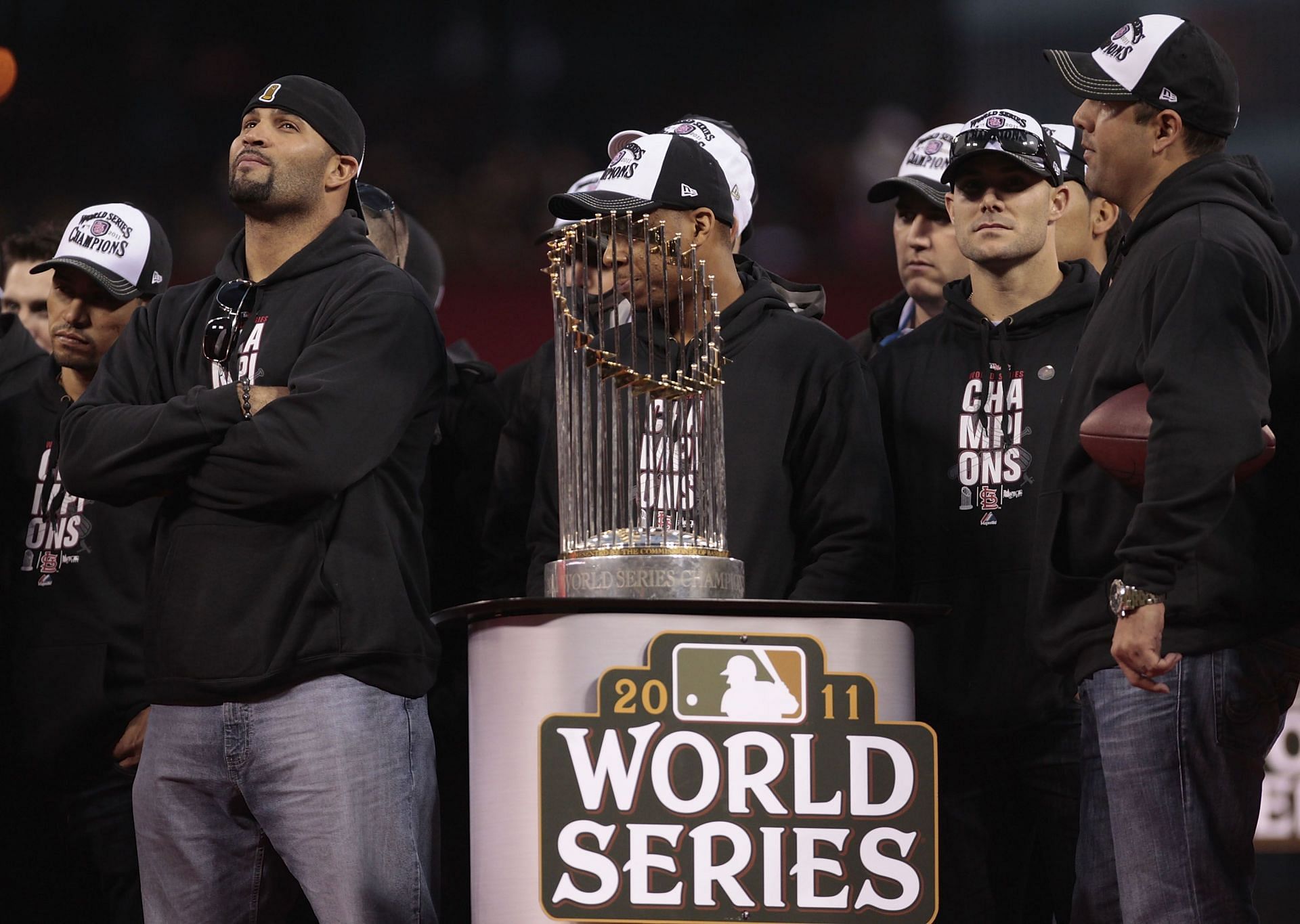 Albert Pujols of the St. Louis Cardinals stands next to the World Series trophy.