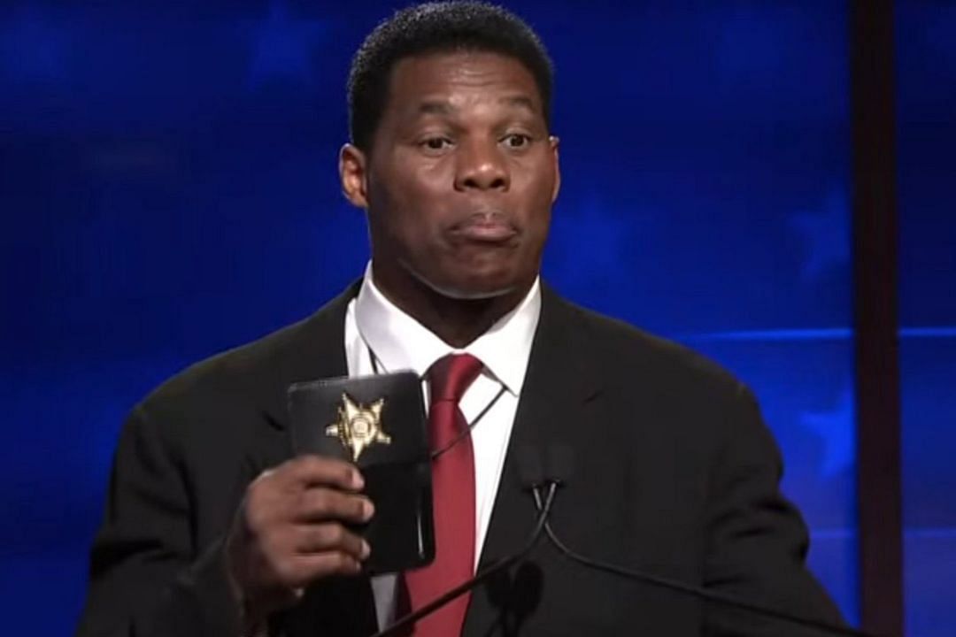 Republican United States Senate candidate Herschel Walker holds up a badge during Georgia Senate debate