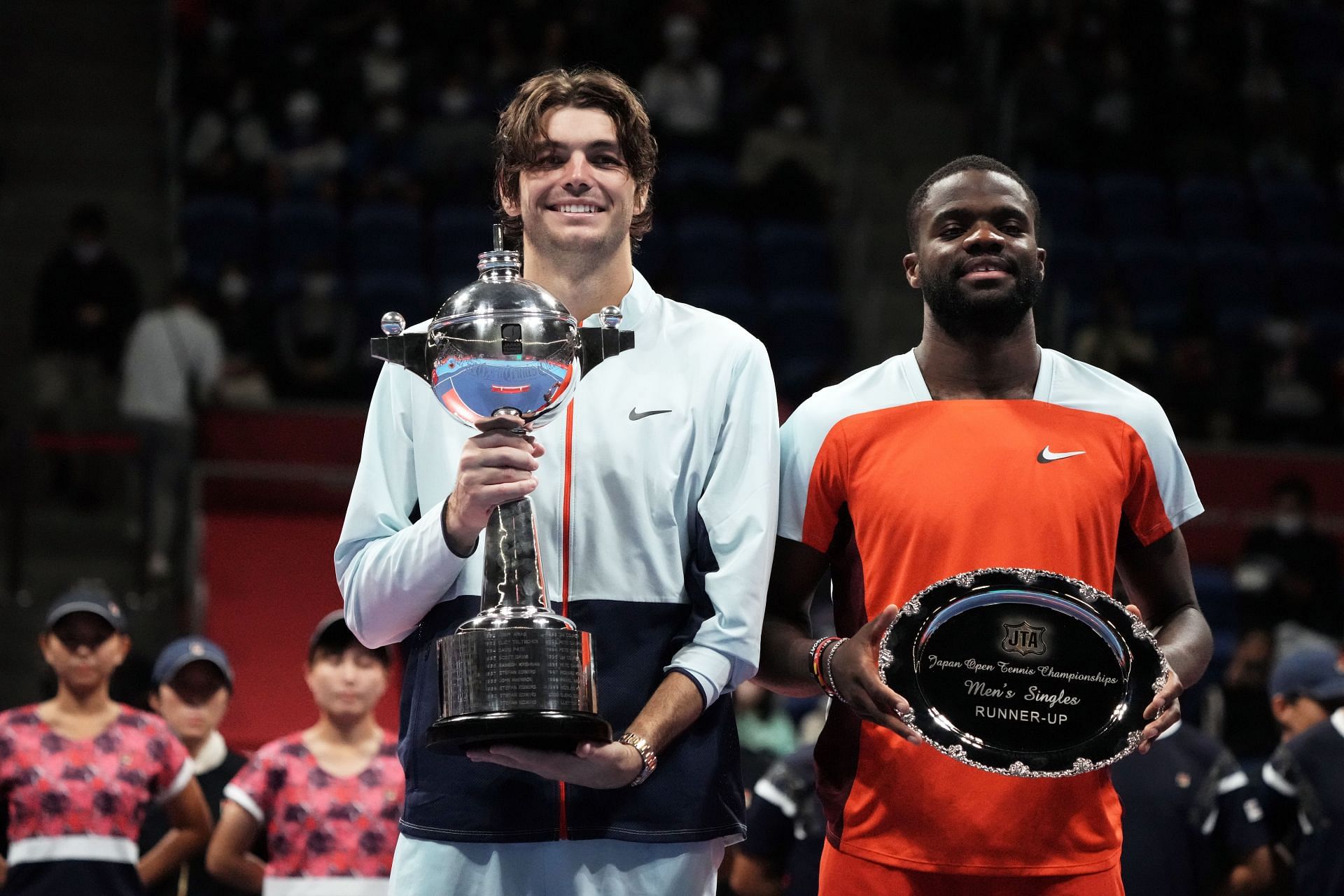 Taylor Fritz of the United States and Frances Tiafoe of the United States pose with their first- and second-place trophies at the Rakuten Japan Open