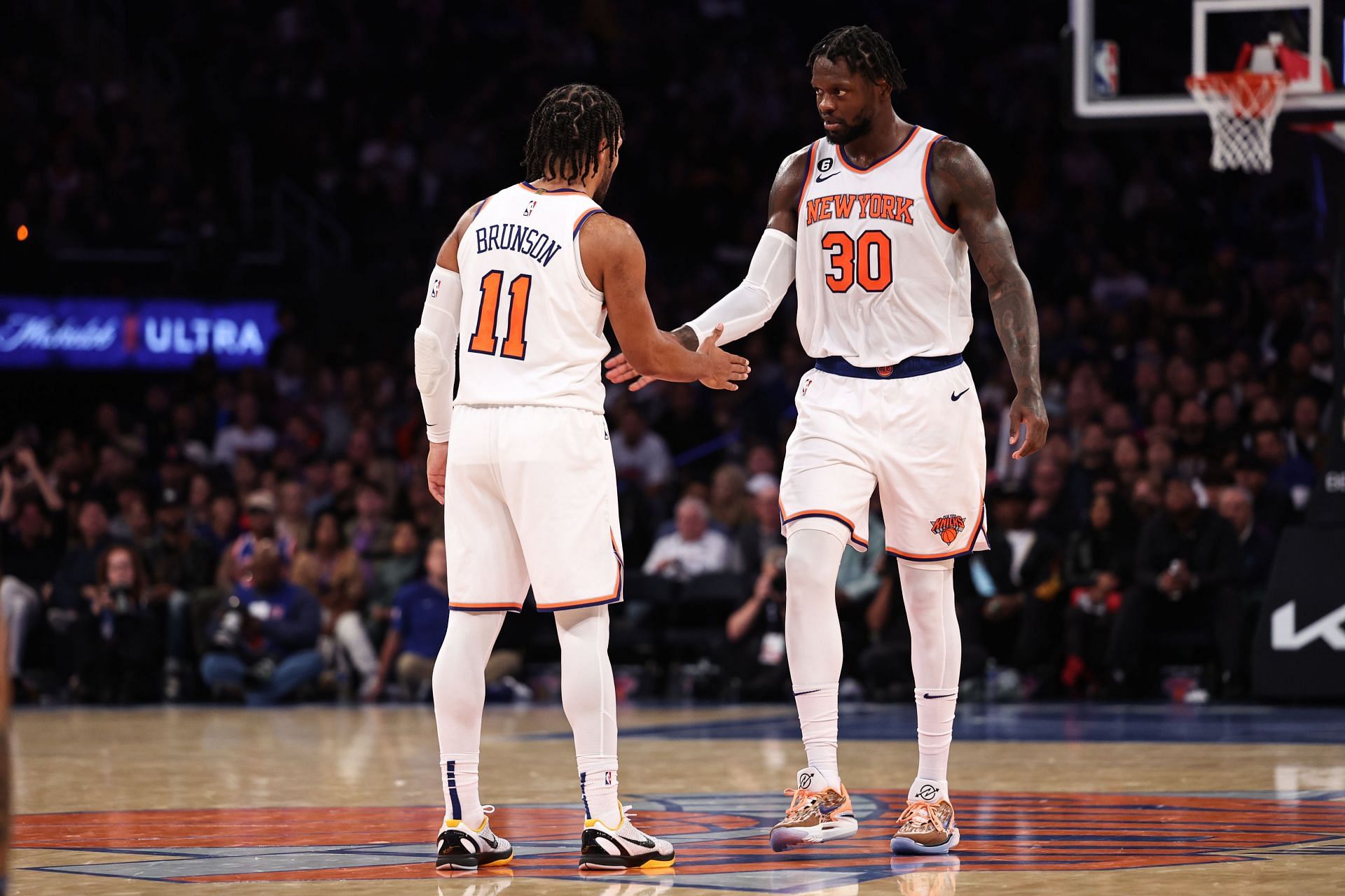 New York Knicks guard Jalen Brunson high-fiving new teammate Julius Randle