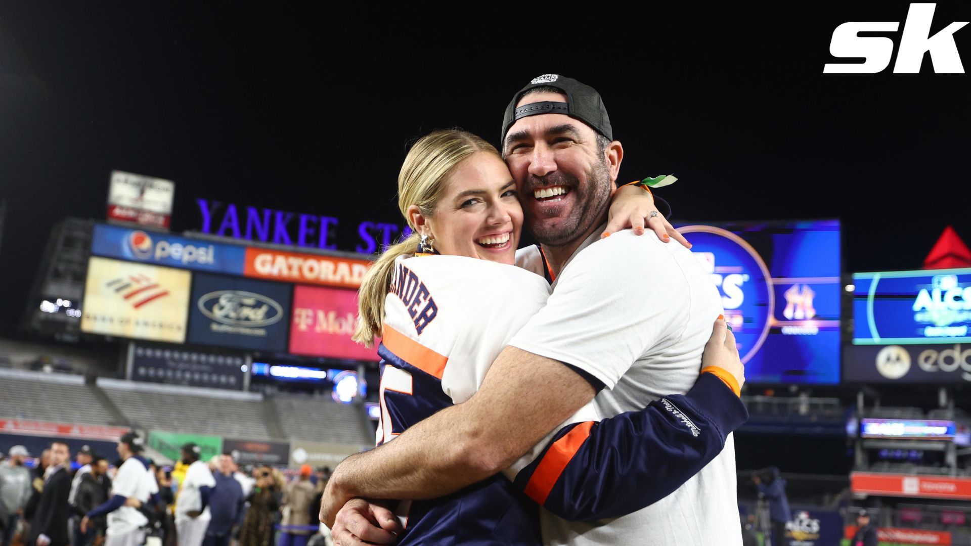 A color, born digital image of Justin Verlander #35 of the Houston Astros  smiling for a photo with his fiancé, American model and actress Kate Upton,  and the game worn jersey that