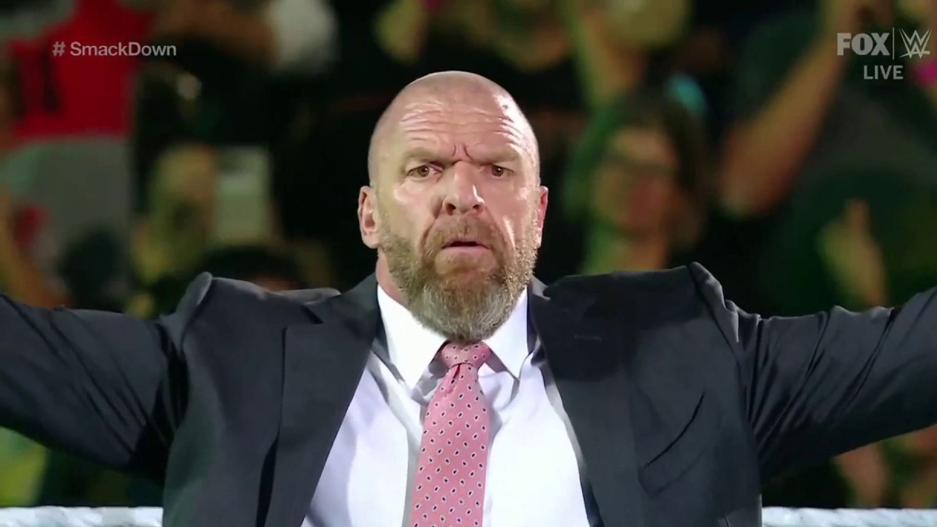 WWE Chief Content Officer Triple H posing in the ring on an episode of SmackDown