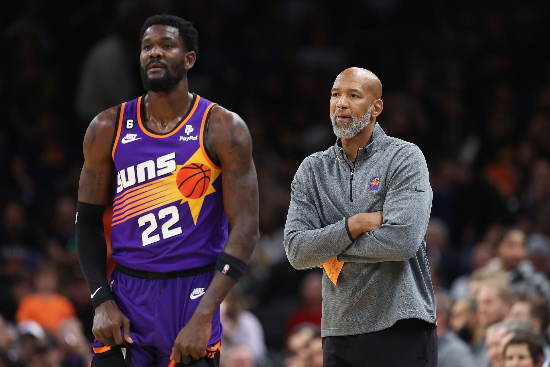 Deandre Ayton and Monty Williams look on at a game