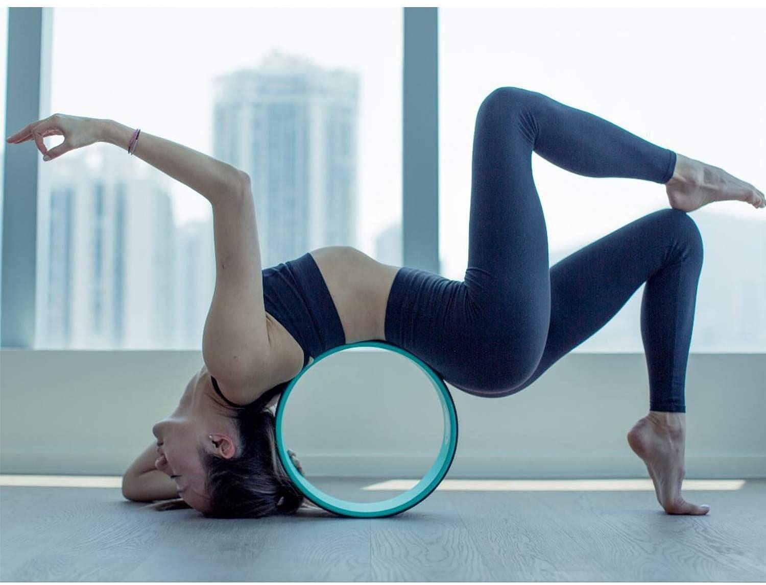 Yoga wheel helps you to deepen your stretches and flexibility while practicing yoga. (Image via www.youryogaclass.com)