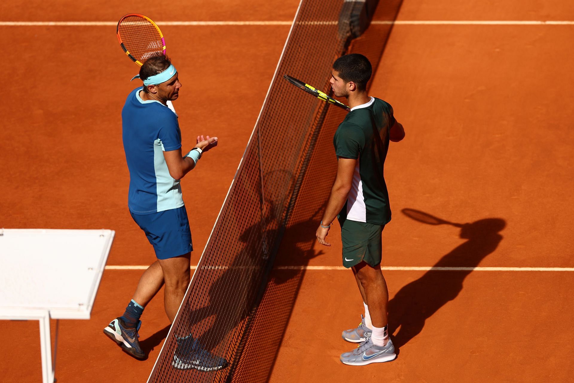 Rafael Nadal of Spain talks with Carlos Alcaraz at the Mutua Madrid Open - Day Nine