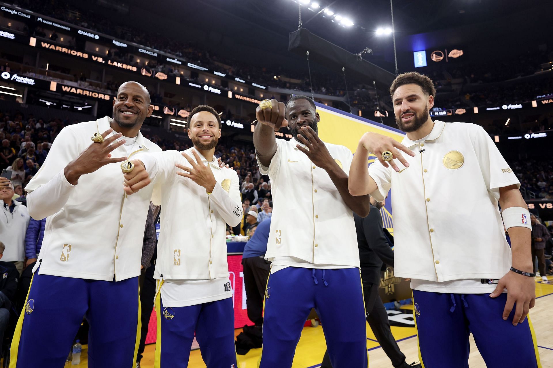 Golden State Warriors players displaying their 2022 NBA championship rings