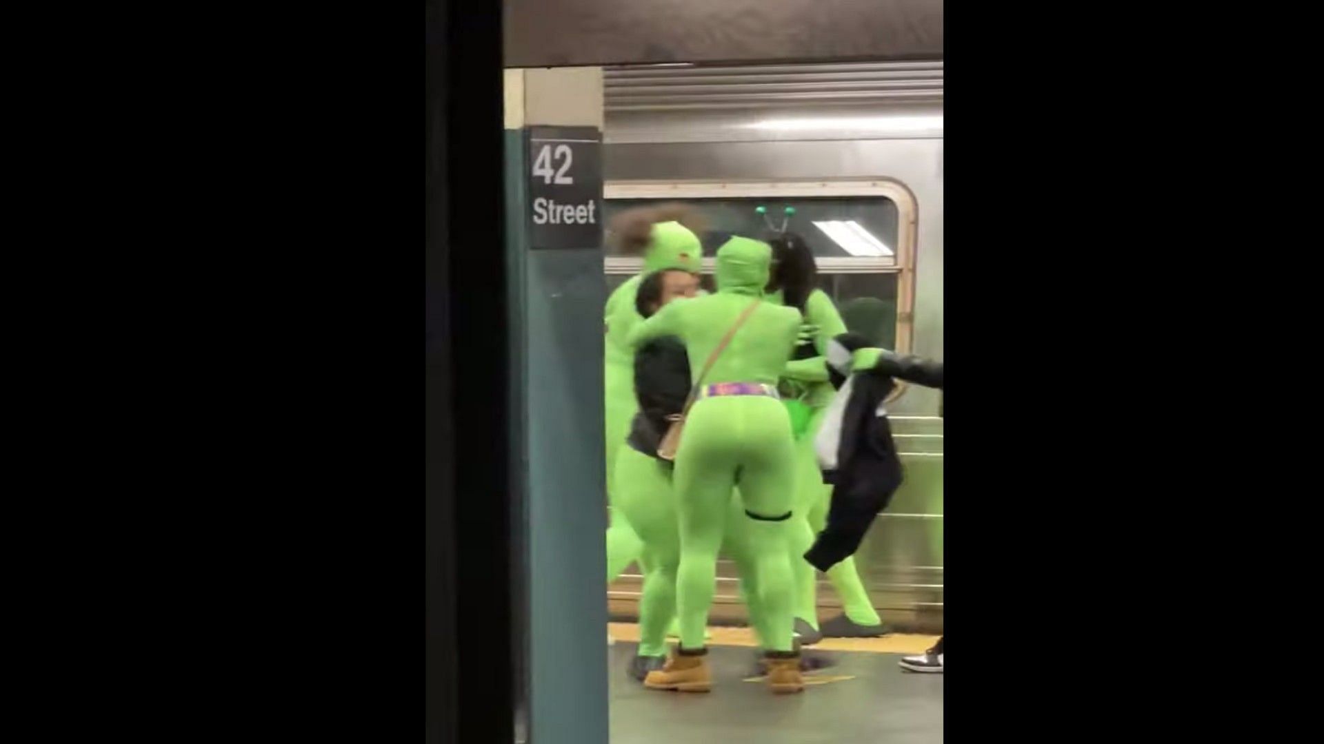 Two young girls were by women wearing neon green leotards in the New York City Subway (Image via Youtube)