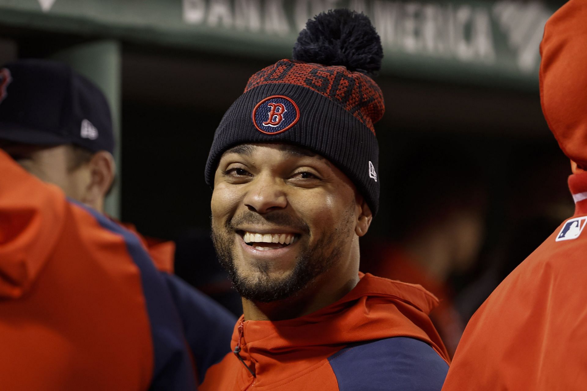 Xander Bogaerts smiles with teammates in the dugout during a game at Fenway Park.