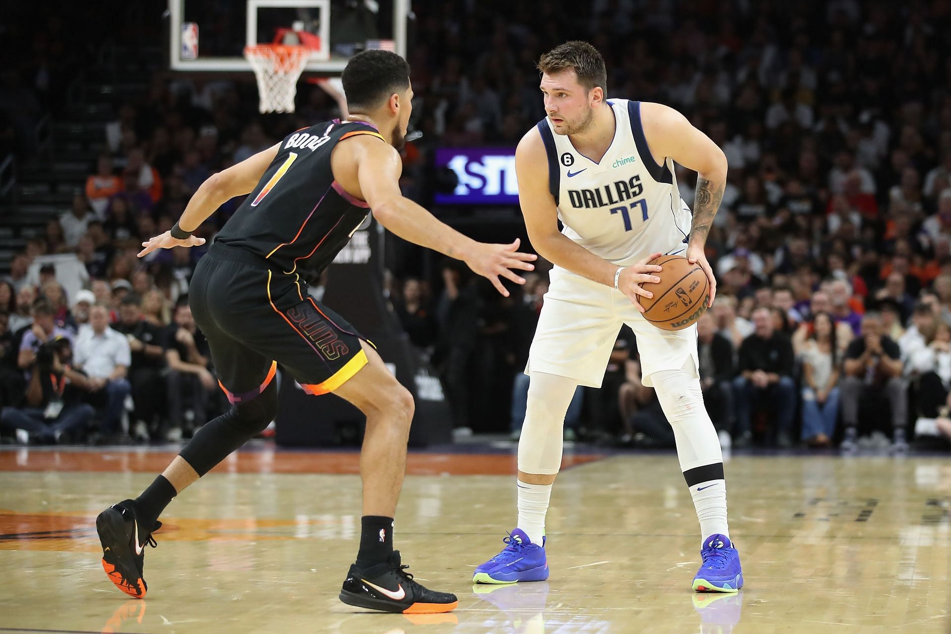 Phoenix Suns All-Star guard Devin Booker defending Dallas Mavericks superstar guard Luka Doncic