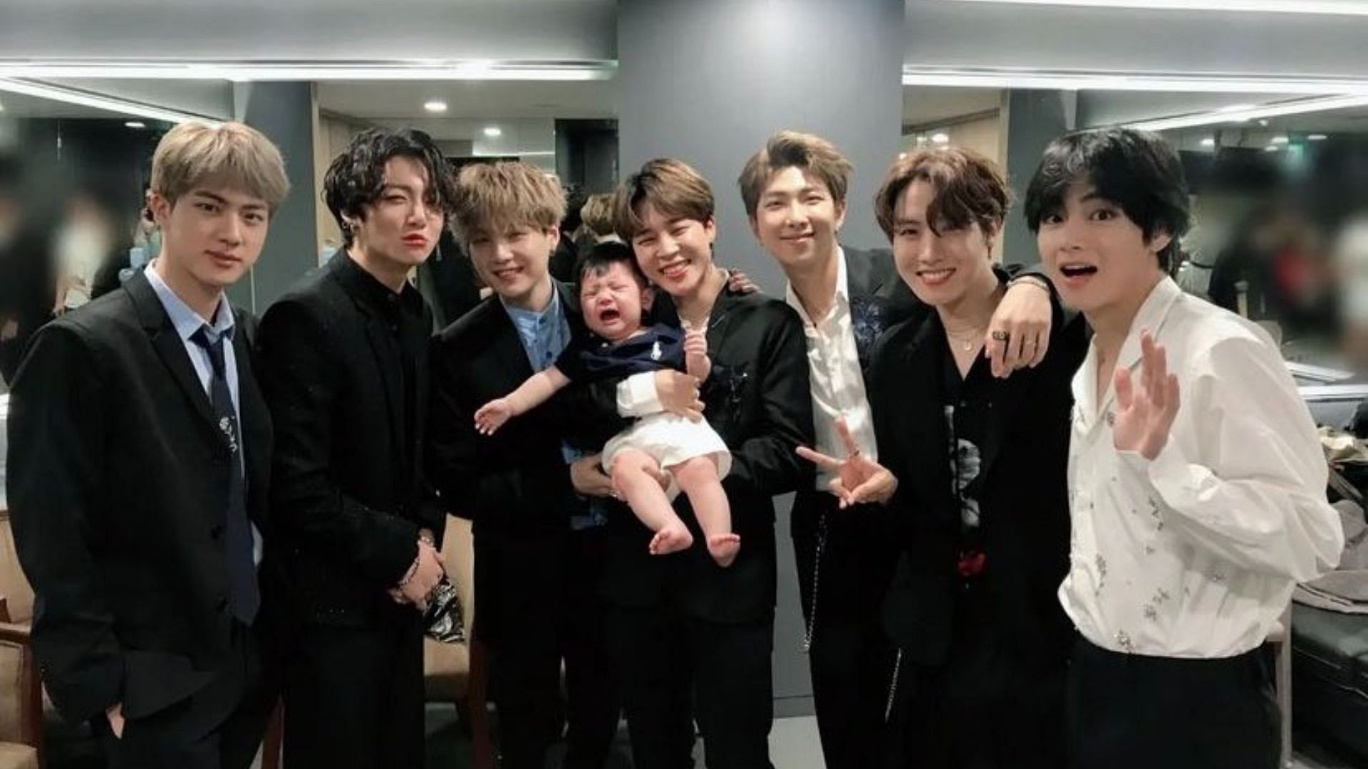 BTS members pose with their manager