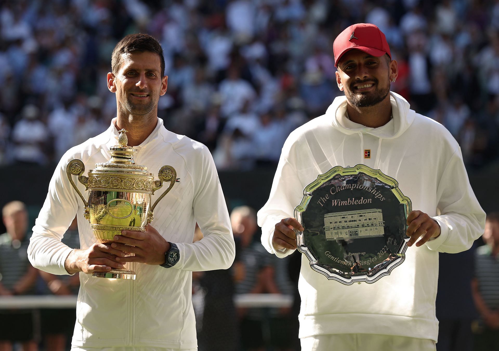 Novak Djokovic (L) and Nick Kyrgios with their respective trophies at Wimbledon 2022
