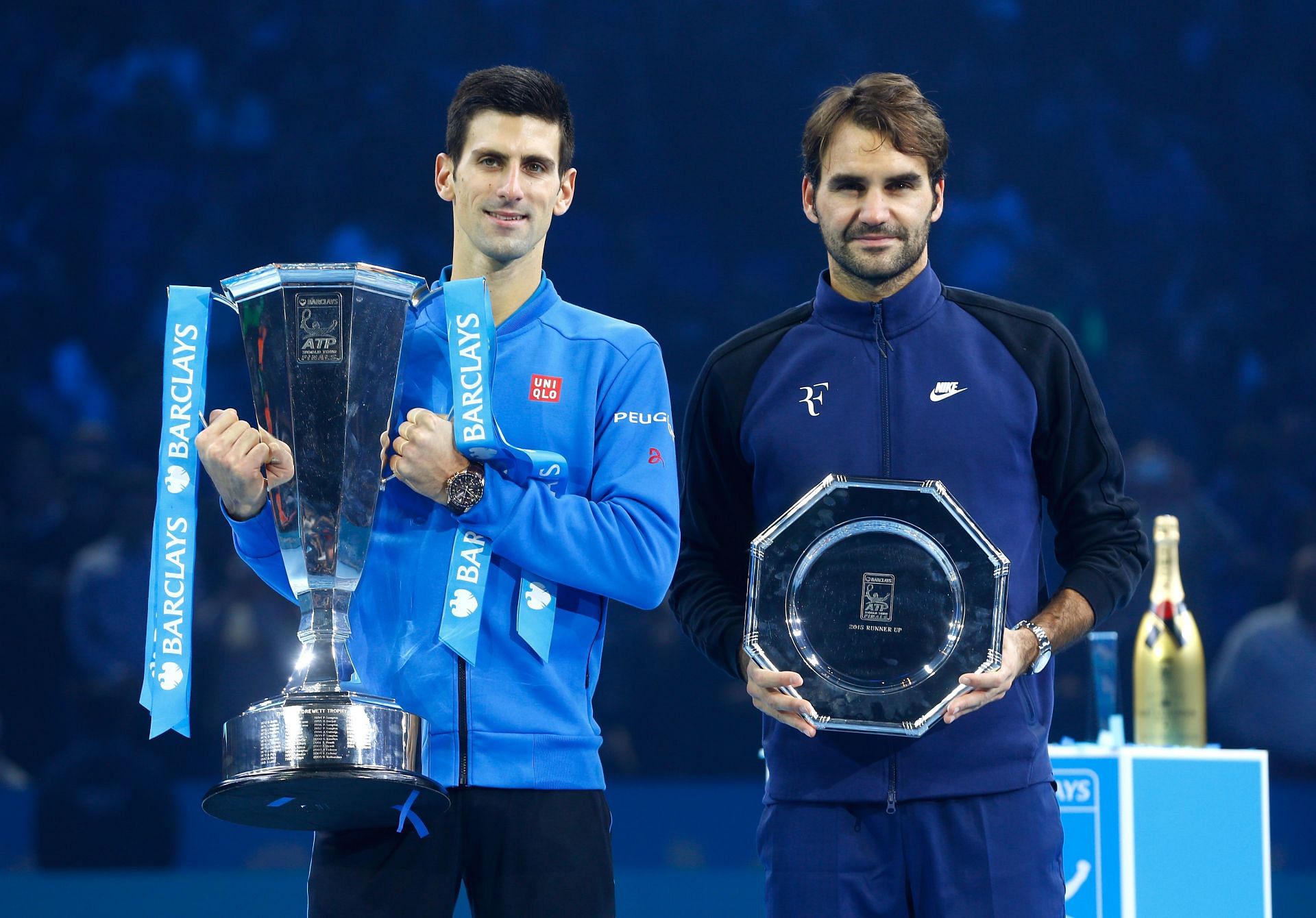 Champion Novak Djokovic (left) and runner-up Roger Federer (right) pose with their respective trophies at the ATP Finals in 2015.
