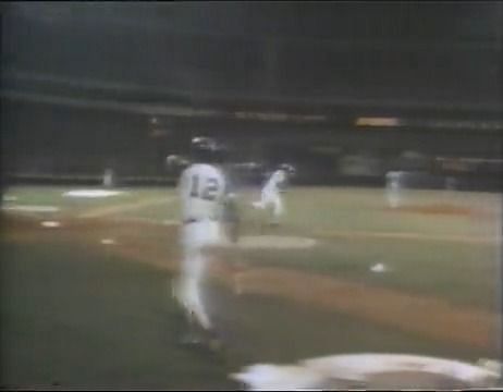 FILE - In this April 8, 1974, file photo, Hank Aaron tips his hat to fans  and teammates, including Dusty Baker (12, wearing batting helmet at center  right), greeting him at home