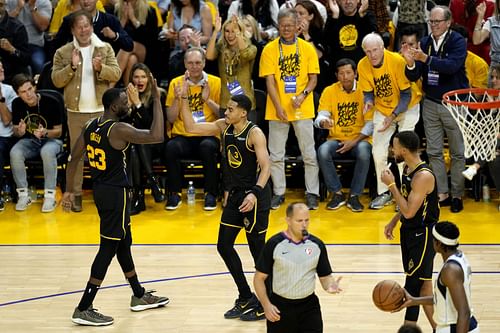 Draymond Green and Jordan Poole of the Golden State Warriors high five each other