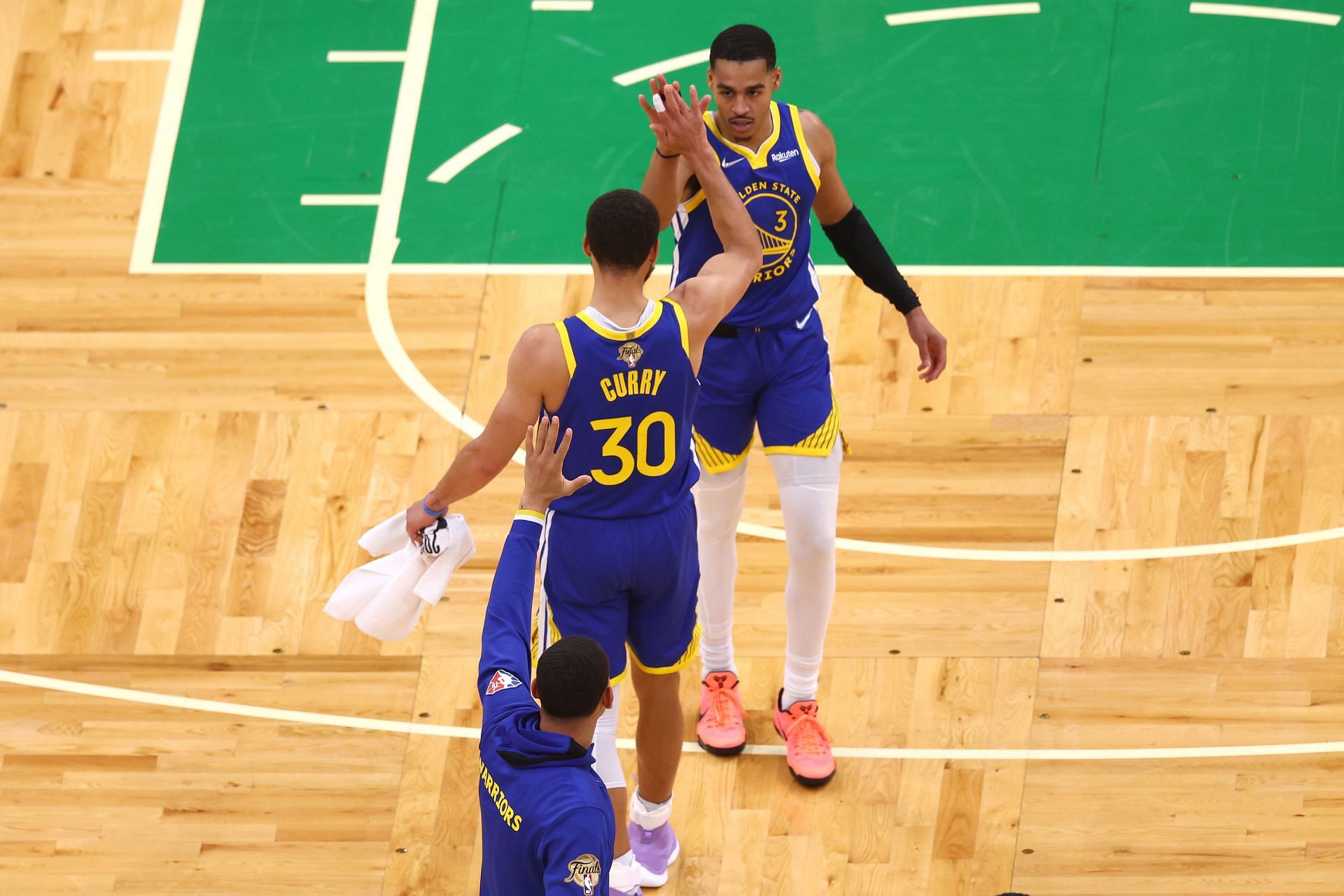 Jordan Poole celebrates a play with Steph Curry