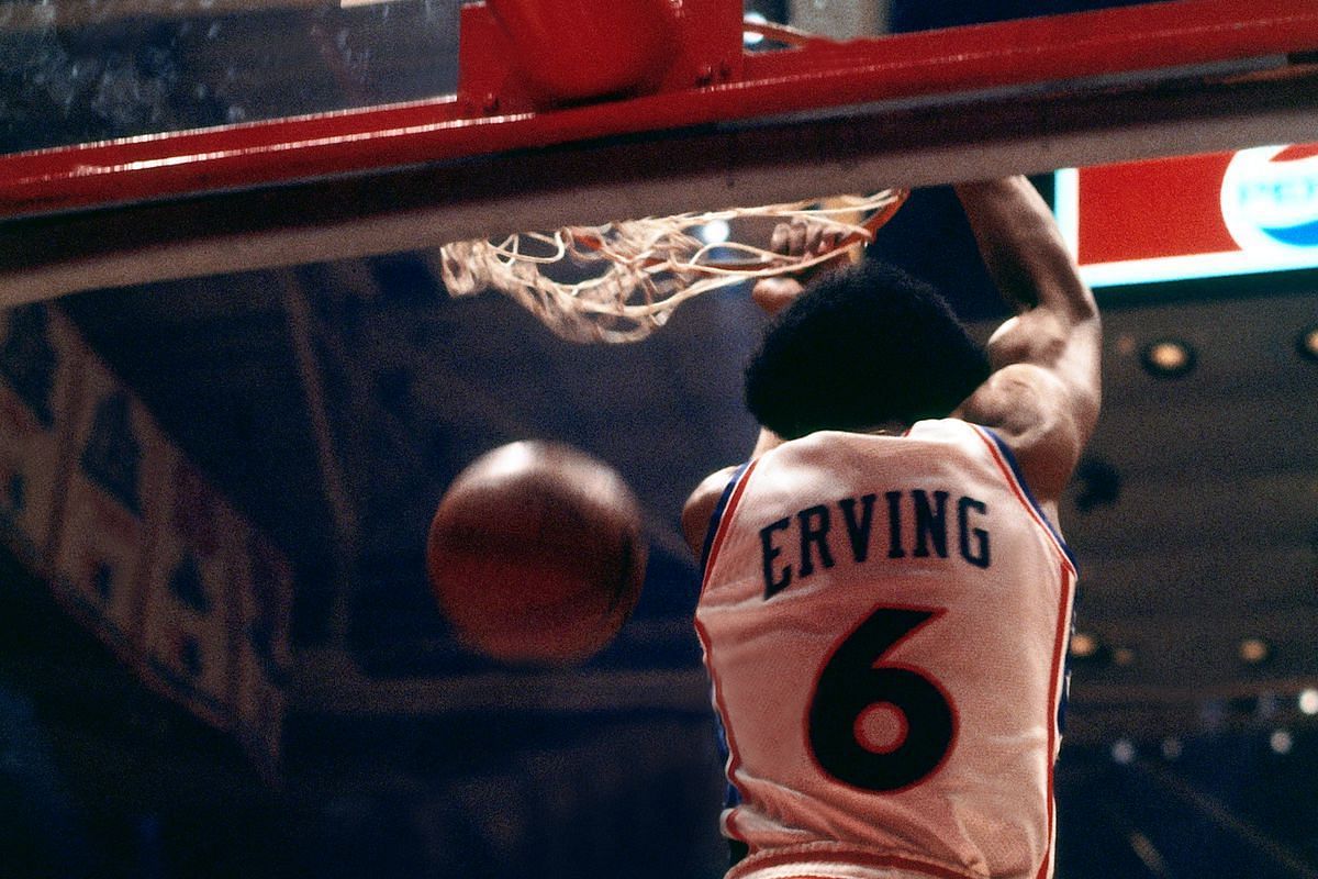 Dr. J throwing a revers dunk.