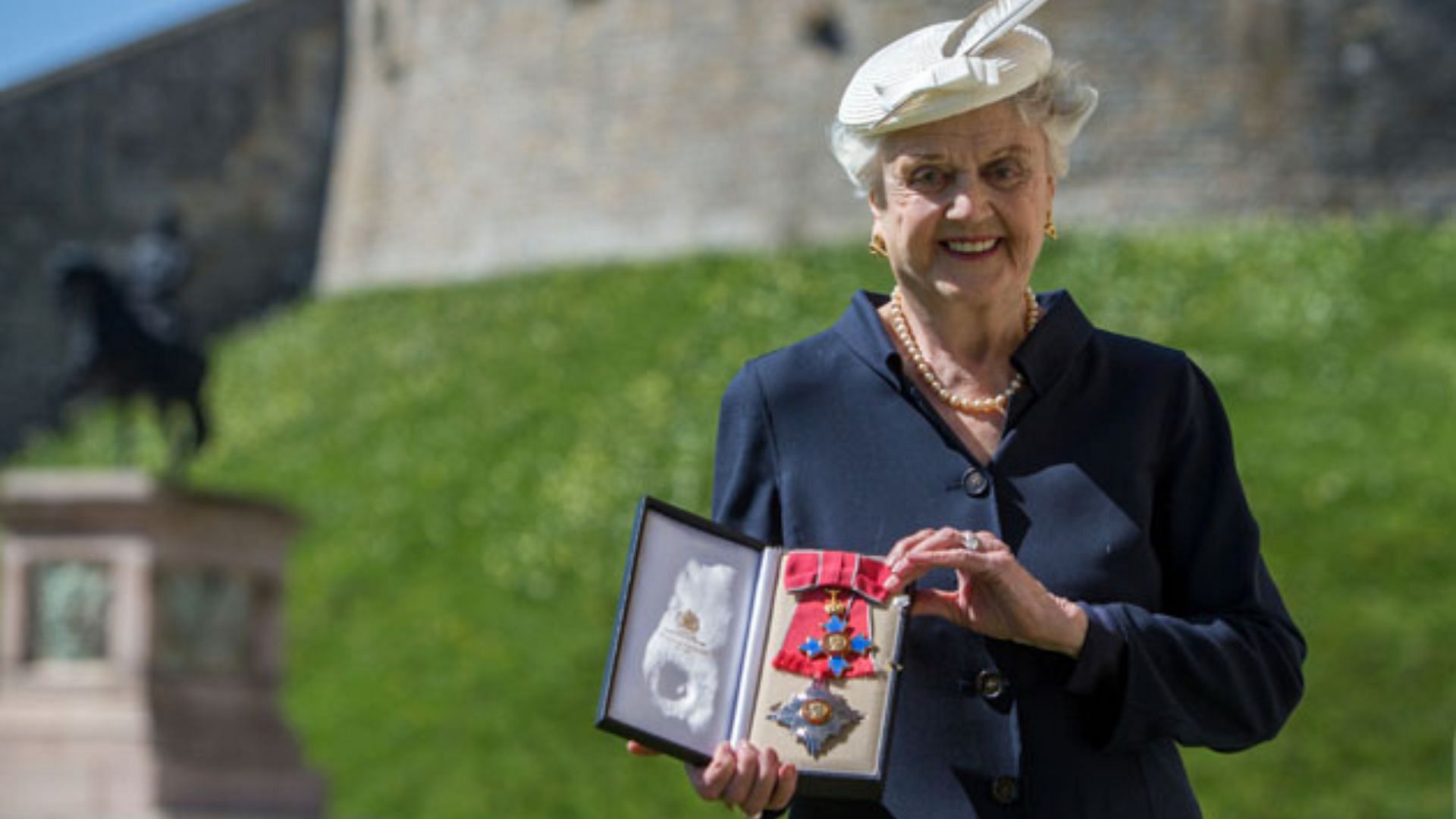 Angela Lansbury after receiving her Dame Commander of the Order of the British Empire (DBE) in 2014 (Image via Getty)