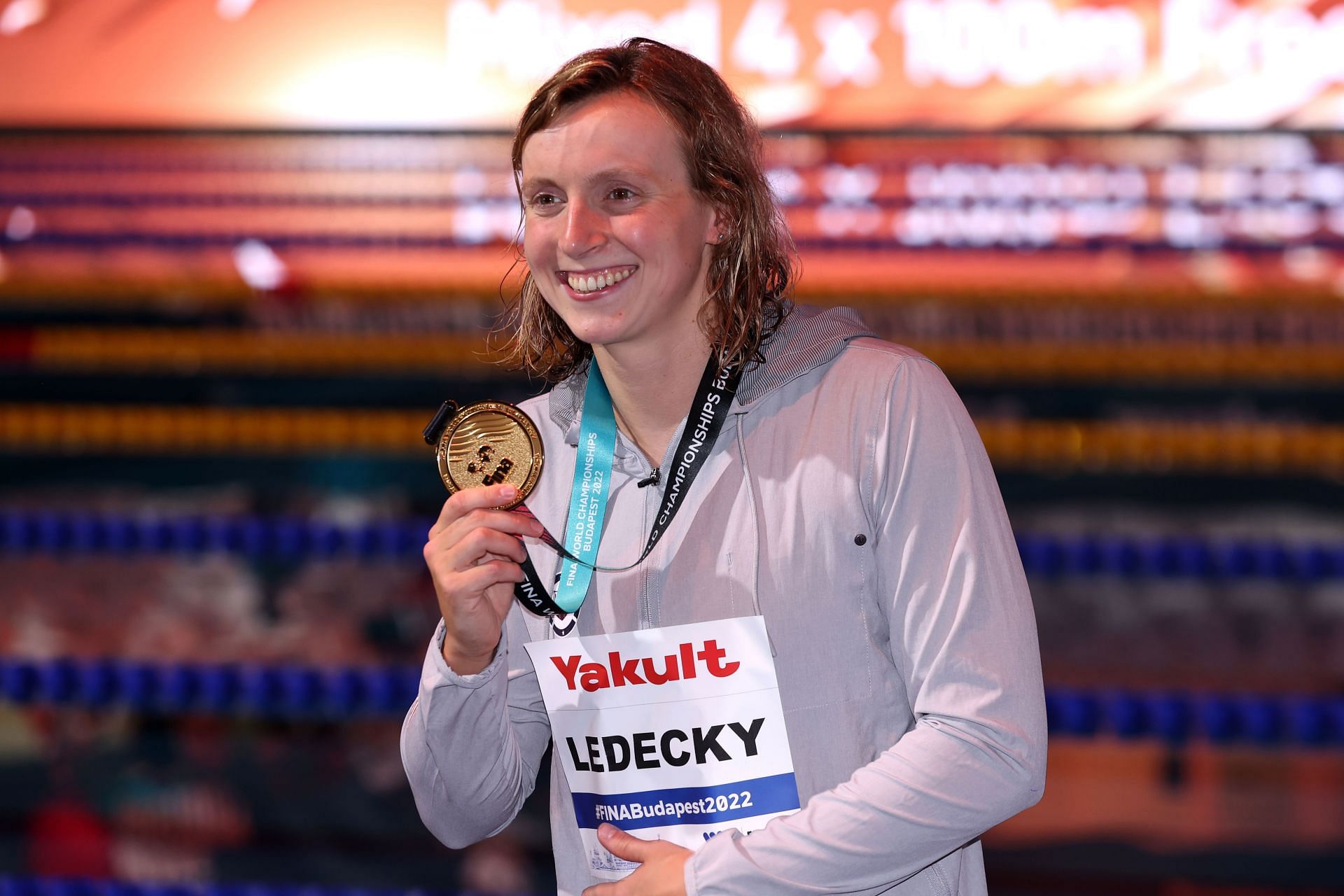 Katie Ledecky poses with the gold medal after winning the 800-meter freestyle at 2022 FINA World Championships