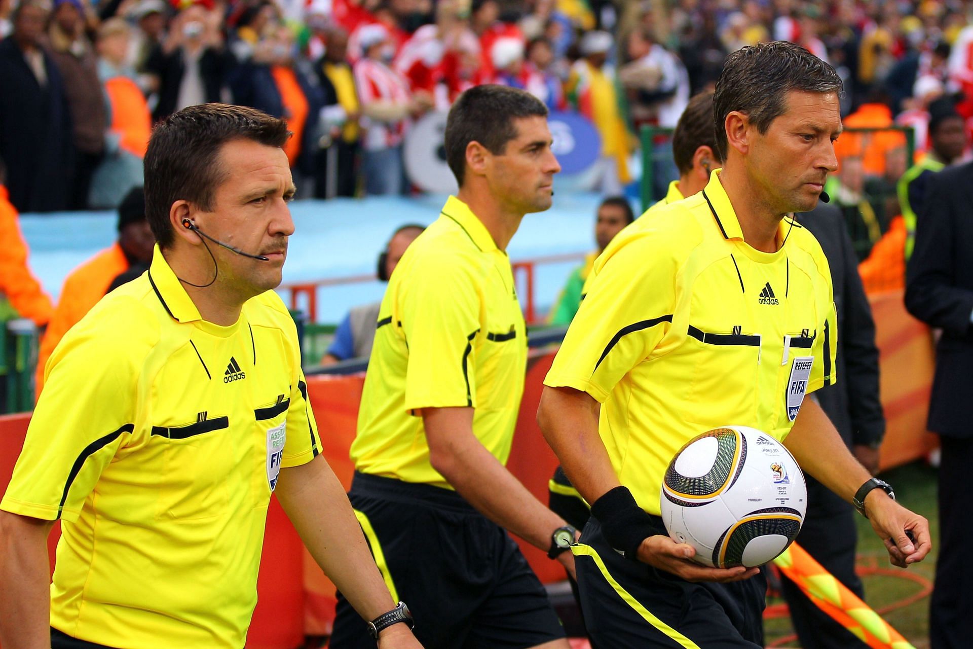 Referee Frank De Bleeckere (R) walks onto the pitch with Assistant Peter Hermans (L) and fourth official Peter O Leary (C) before the 2010 FIFA World Cup South Africa Round of Sixteen matches between Paraguay and Japan.