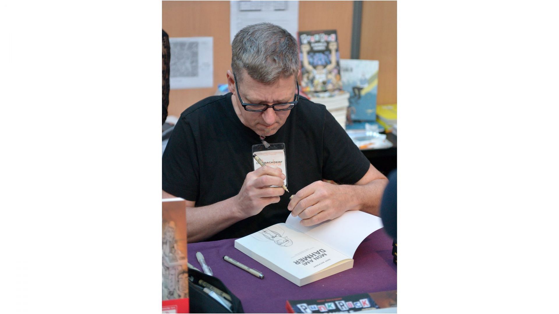 Derf Backderf signs copies of his book in French at the Angouleme Festival (Image via Wikipedia/Stephane Mahot)