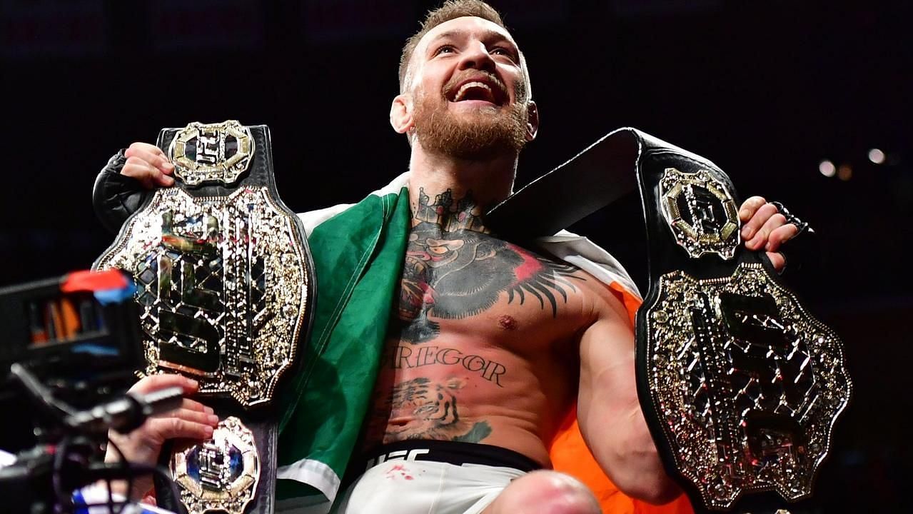 Conor McGregor with both UFC titles