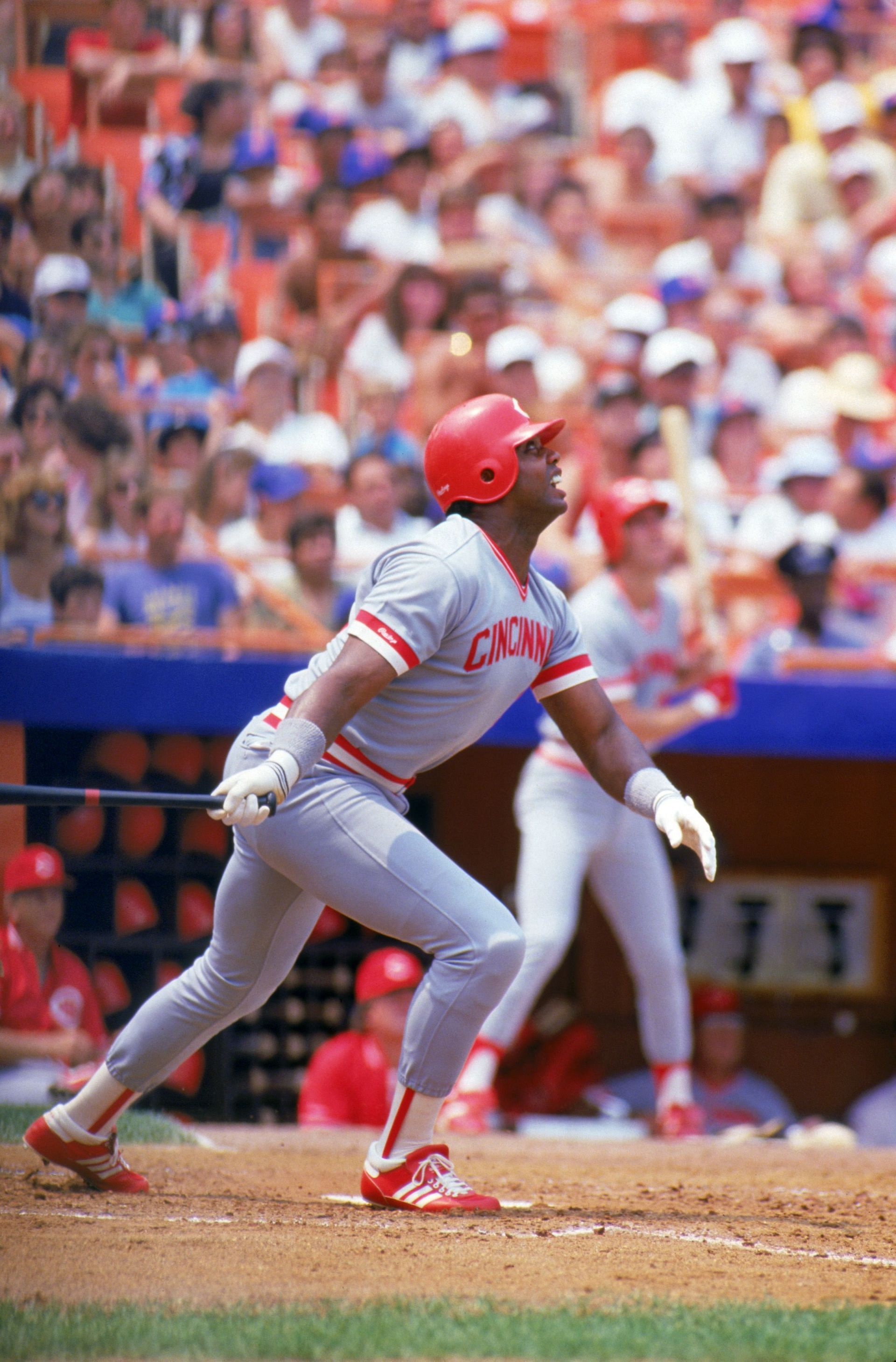 Dave Parker #39 of the Cincinnati Reds watches the flight of the ball as he follows through on his swing during a game with the New York Mets in 1987 at Shea Stadium in Flushing, New York.