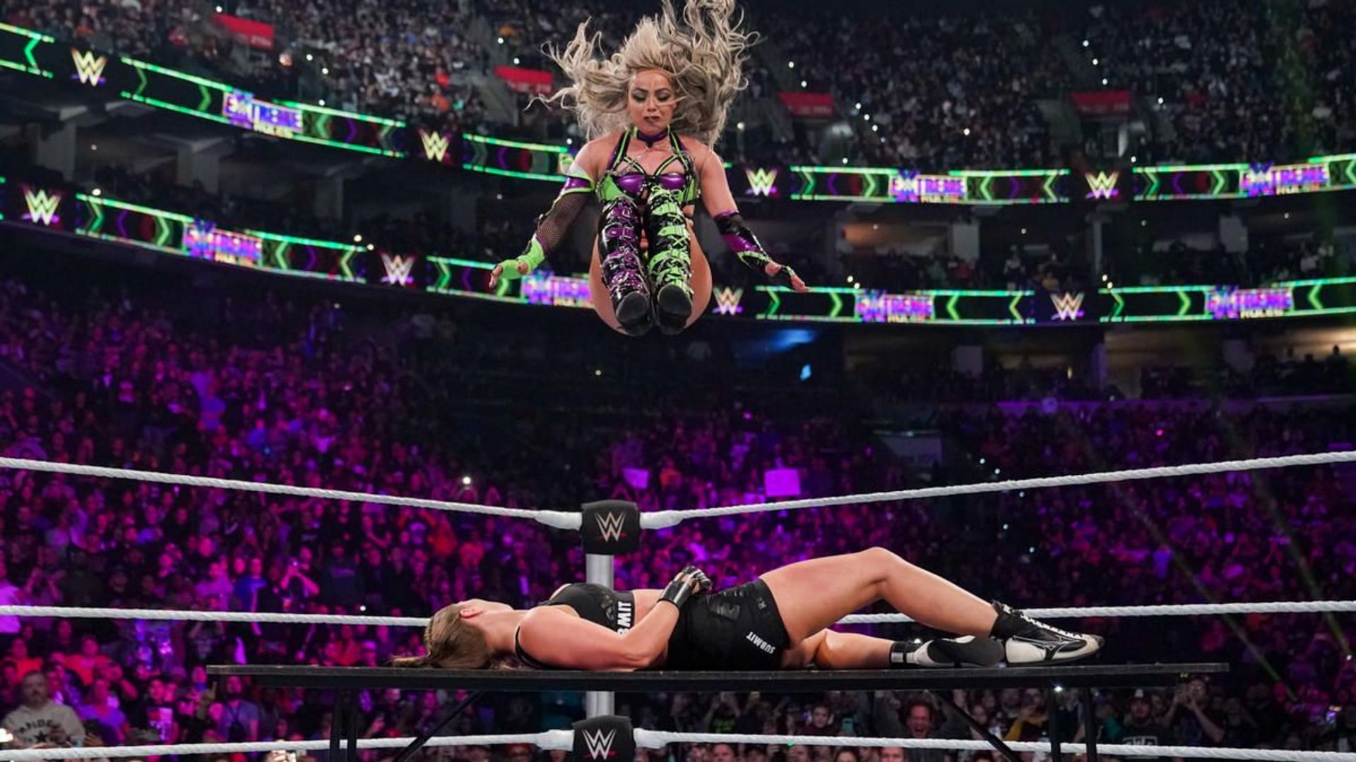 Liv Morgan putting Ronda Rousey through a table (Source: WWE.com)