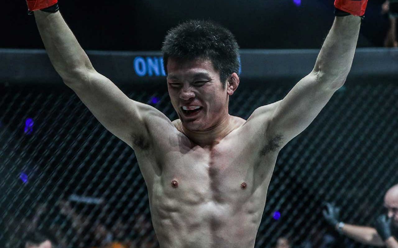 Shinya Aoki with arms raised after a fight 